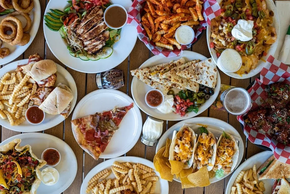Variety of American comfort food platters with pizza and tacos
