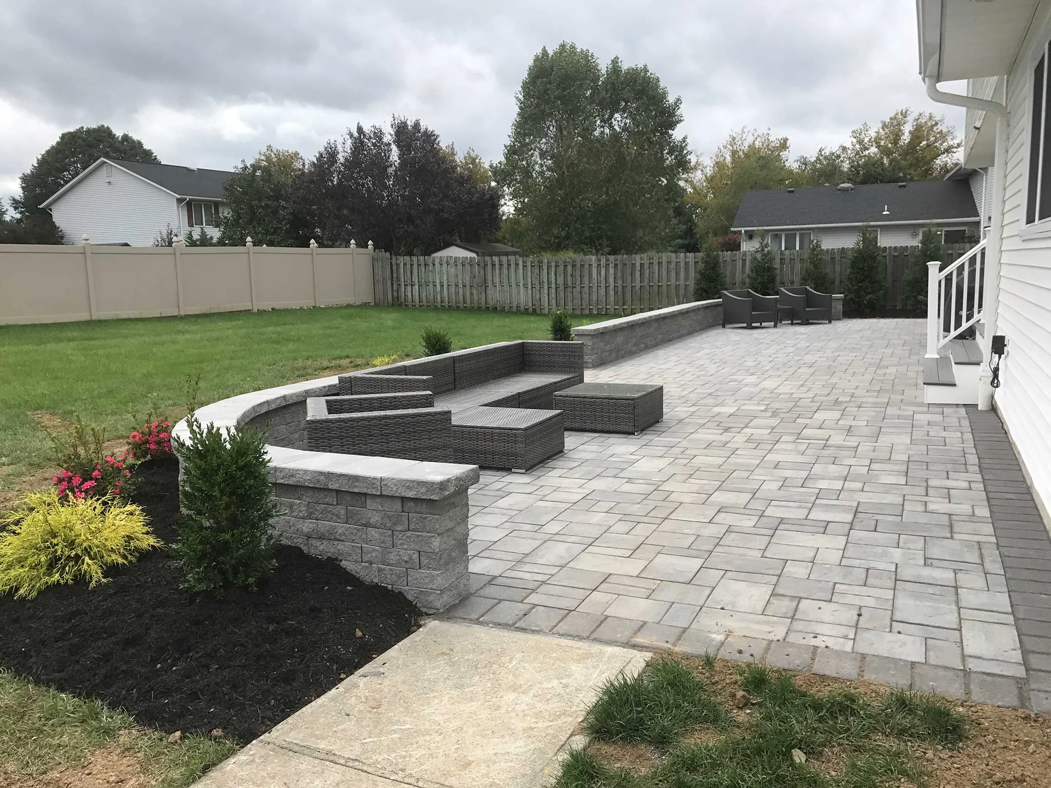 Modern outdoor patio with seating and landscaping