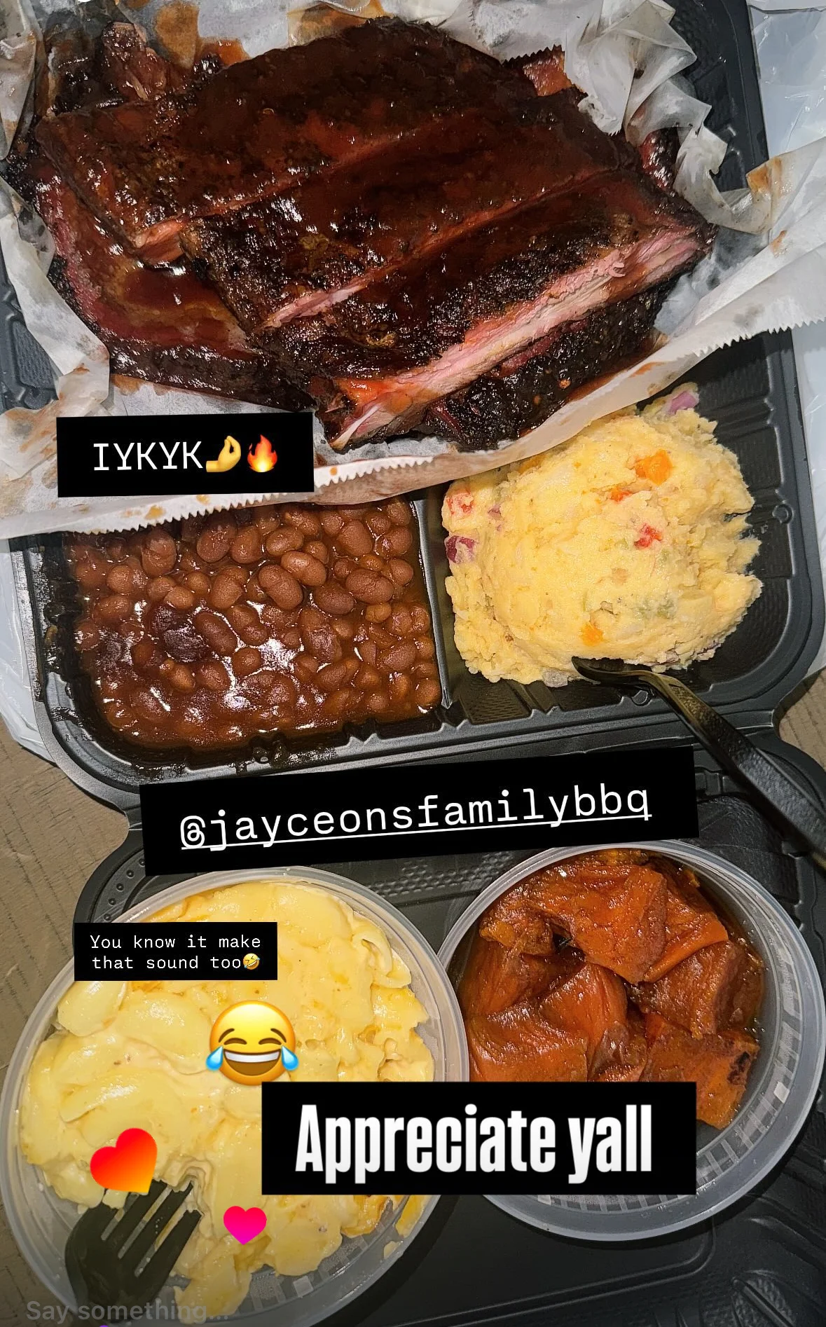 A BBQ meal served in a takeout container, featuring smoked ribs, baked beans, and creamy macaroni.