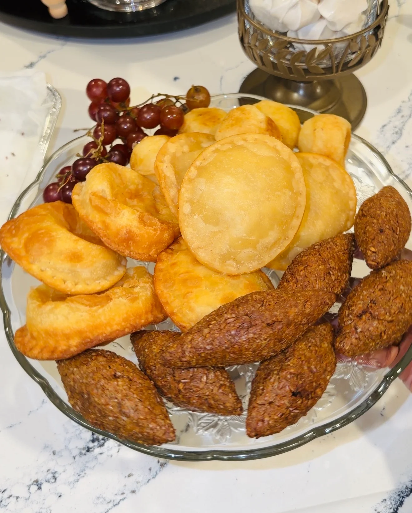 Assorted Middle Eastern pastries including kibbeh and fried dough