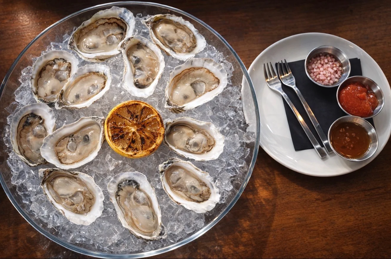 Freshly shucked oysters on ice with garnishes