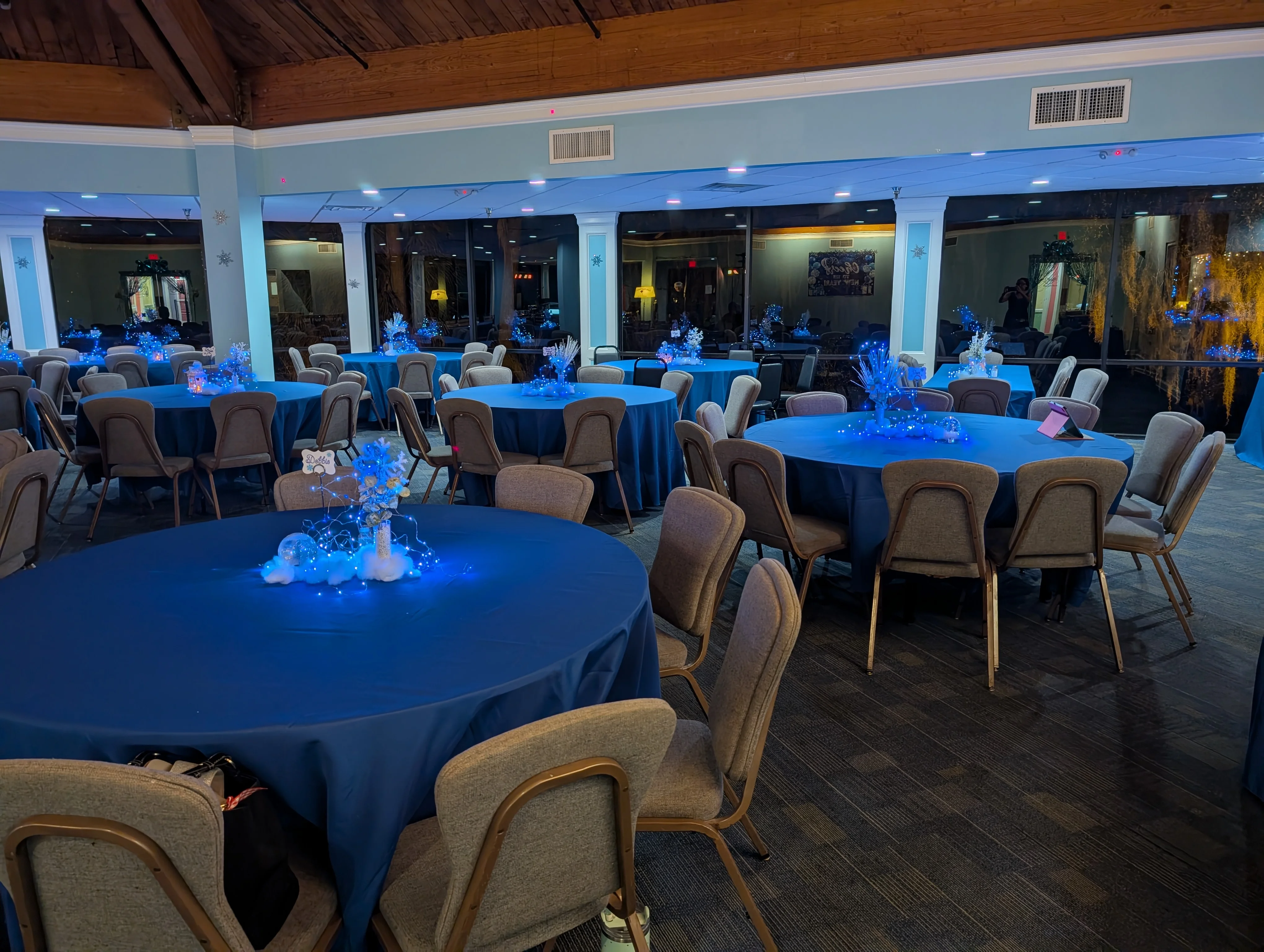Elegant restaurant event setup with tables and decorations.