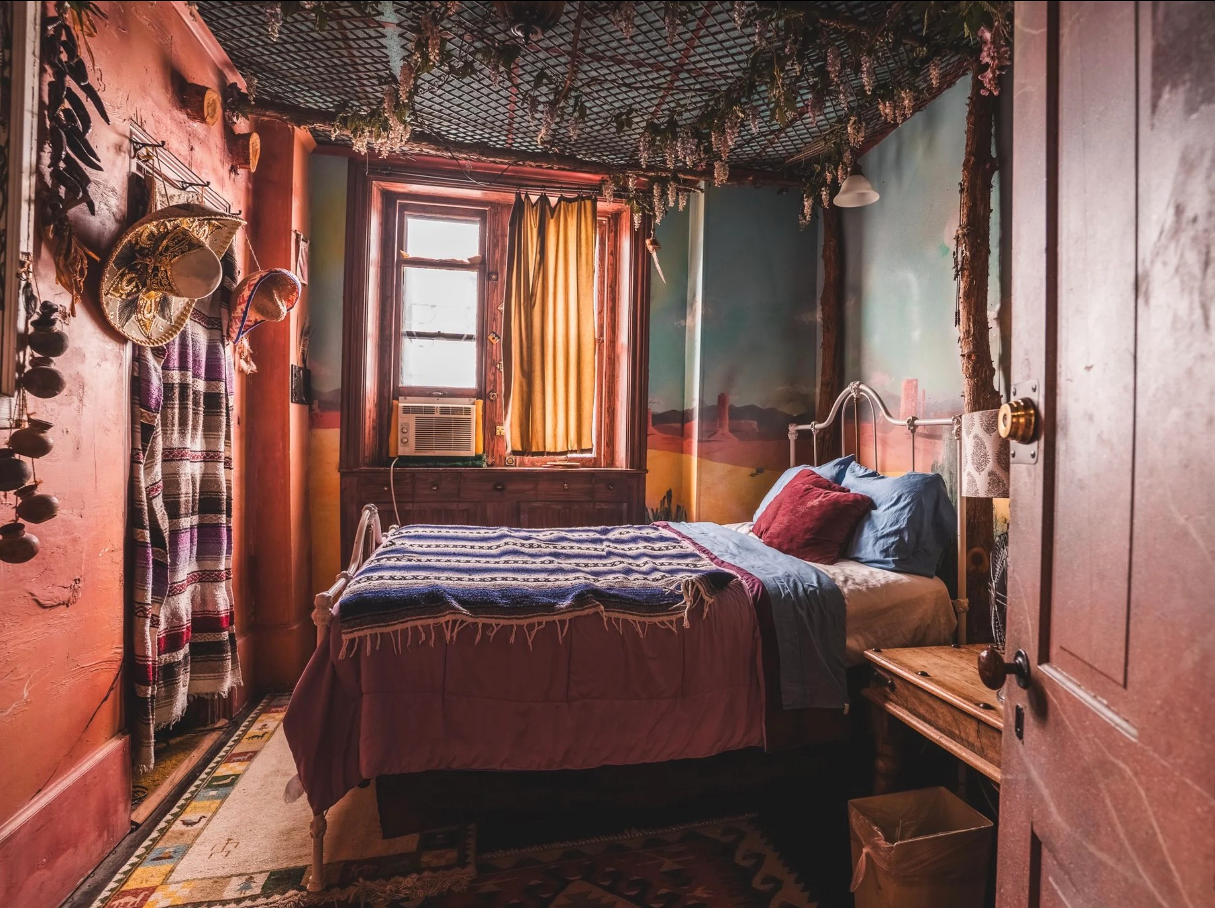 Cozy bedroom with colorful decor and a warm atmosphere.