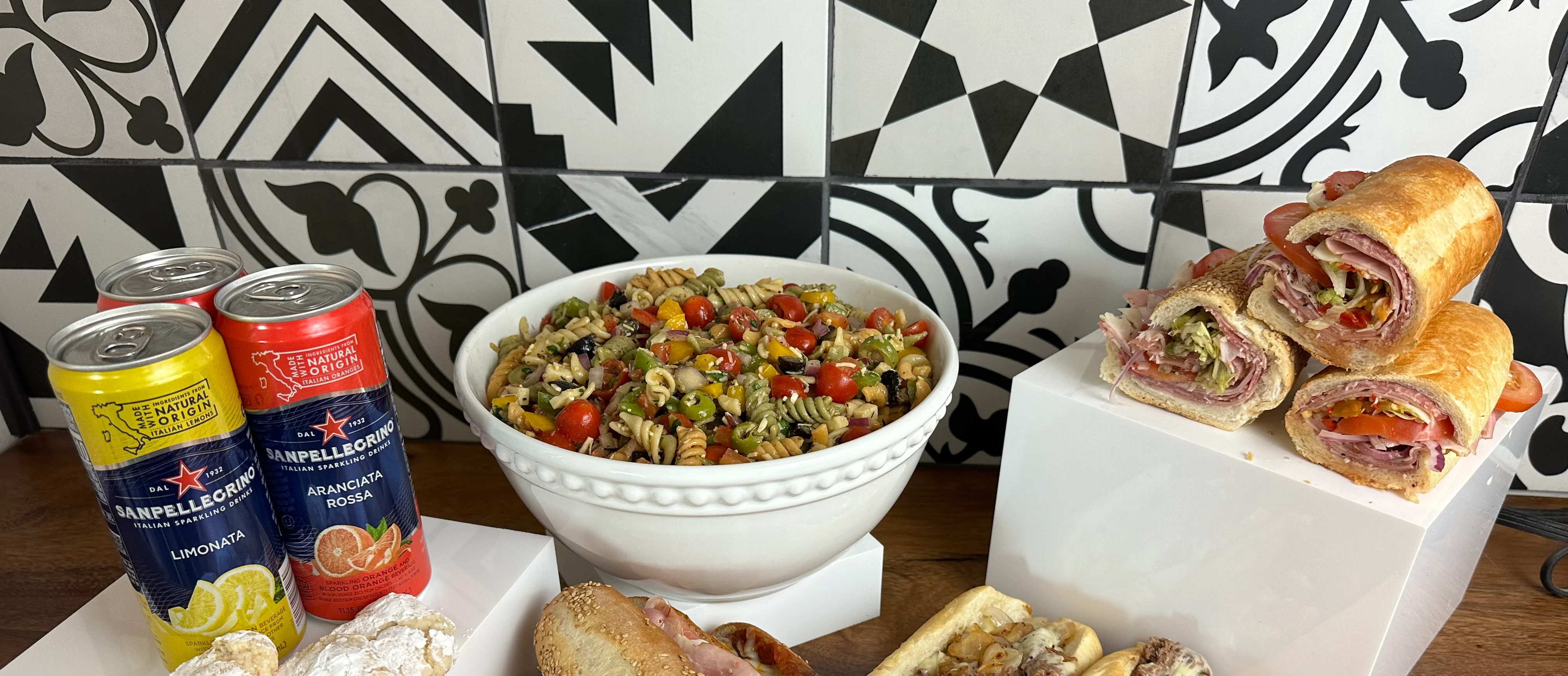 Italian deli platter with sandwiches and pasta salad