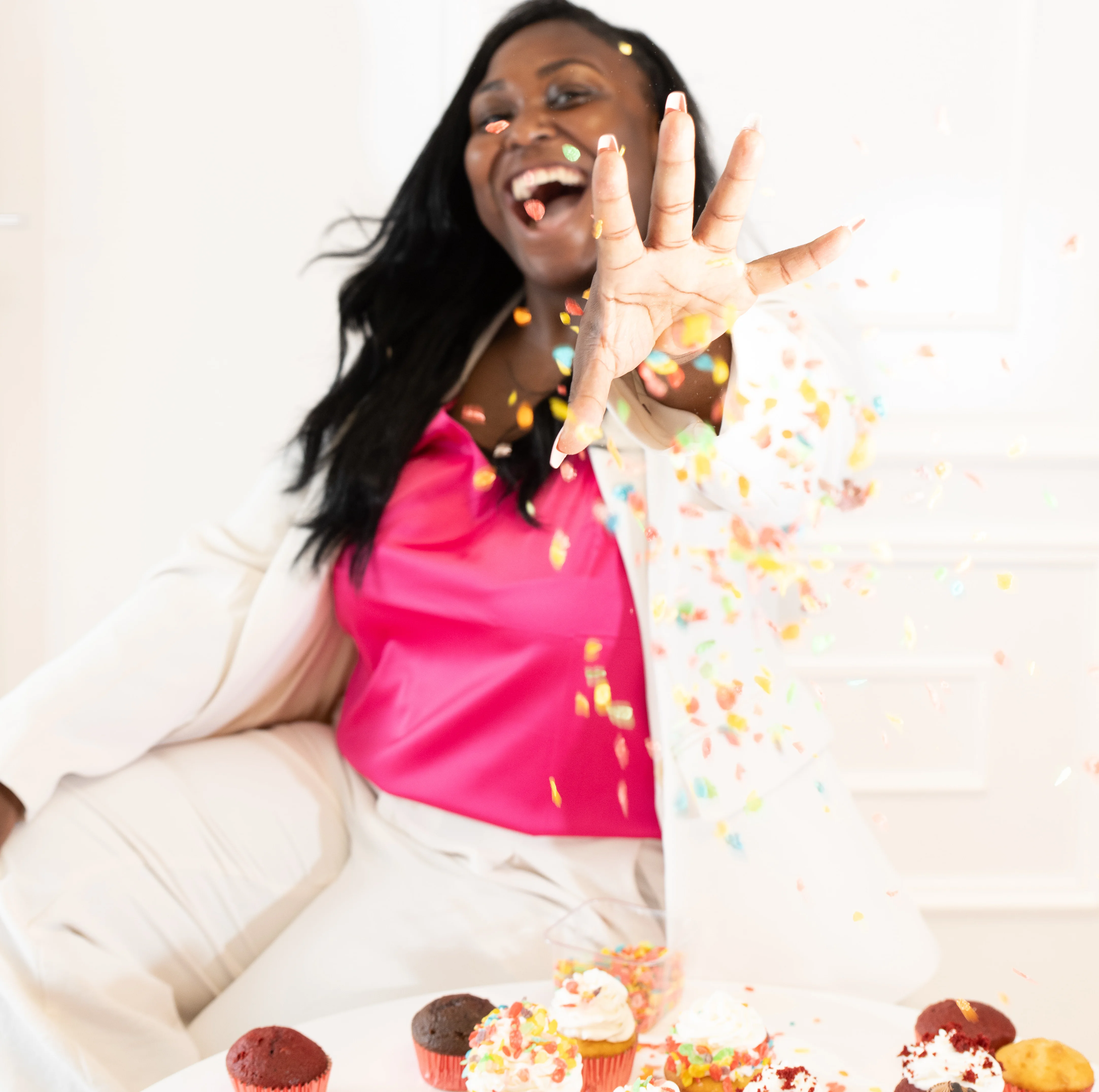 Celebratory moment with colorful confetti and cupcakes