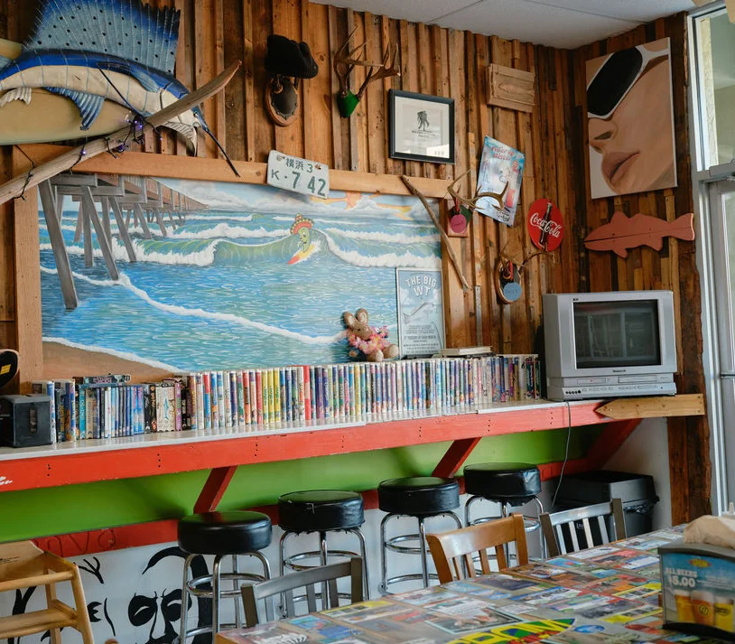 Cozy restaurant interior with surf-themed decor and wooden accents