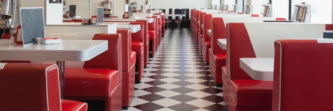 Retro diner interior with red booths and checkered floor