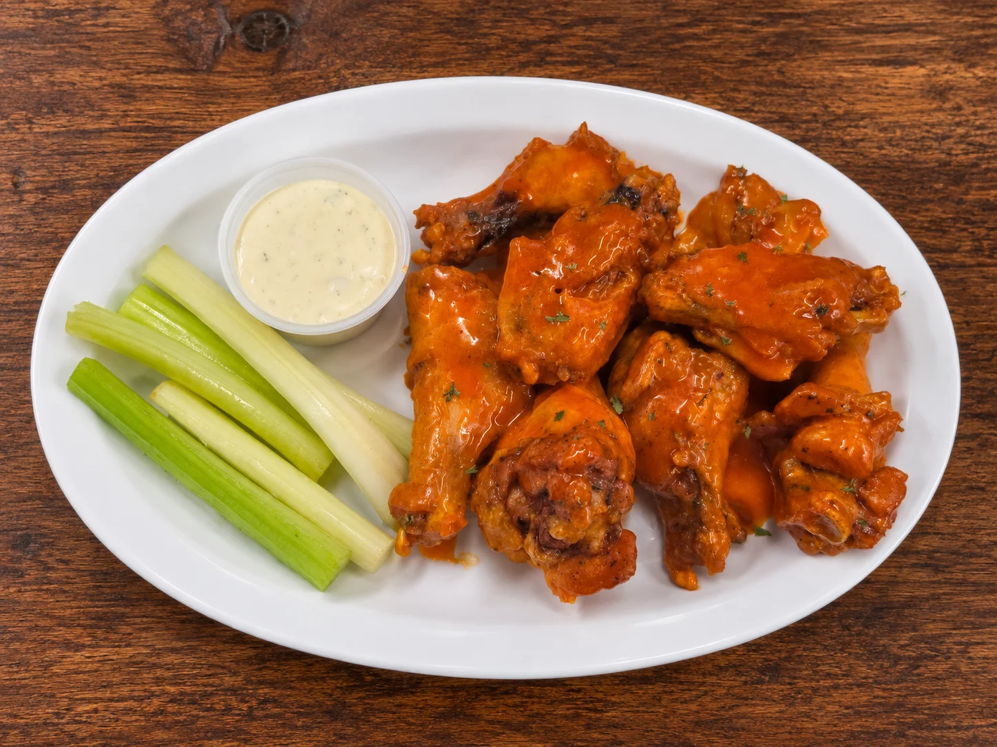 Buffalo chicken wings with celery and ranch dressing