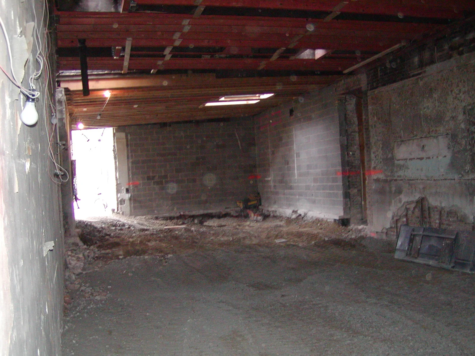 Construction site interior with exposed beams and gravel floor