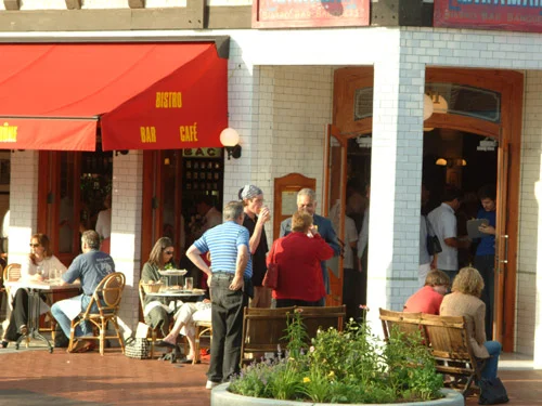 Outdoor dining scene at a bistro with patrons enjoying their meals