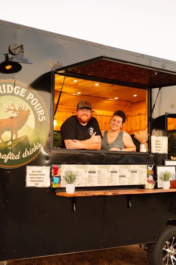 Friendly staff at a mobile drink truck serving crafted beverages
