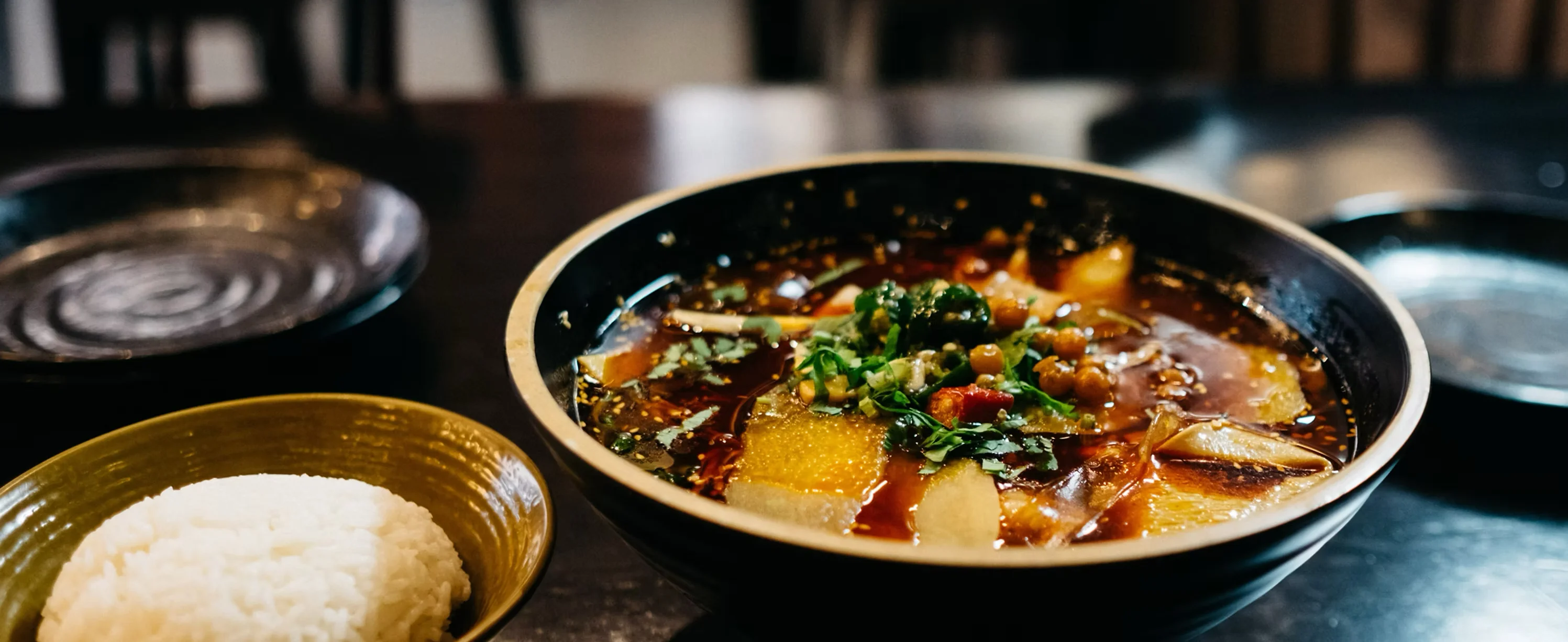 Spicy Sichuan hot pot with vegetables and herbs