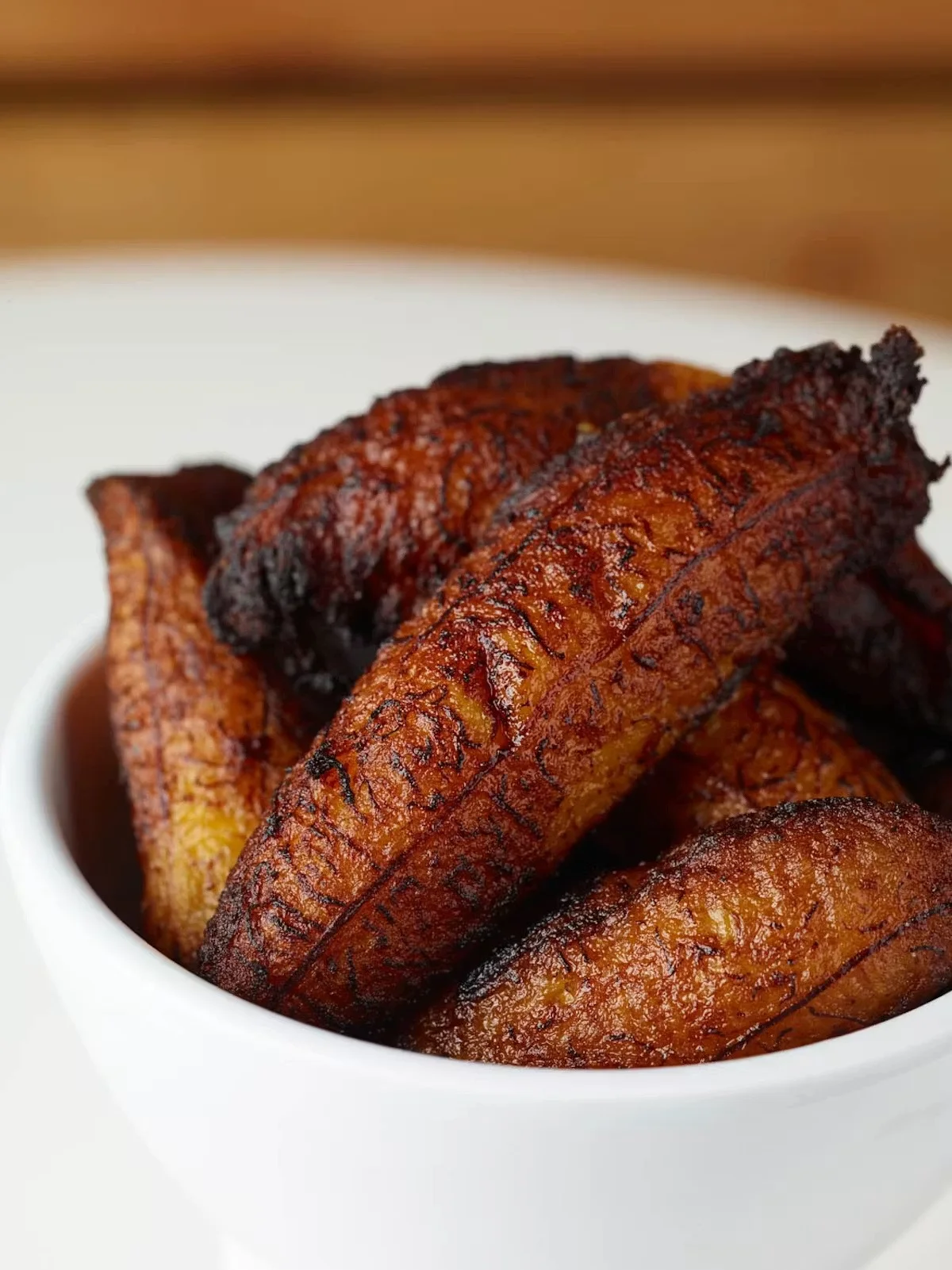 Crispy fried plantains served in a white bowl