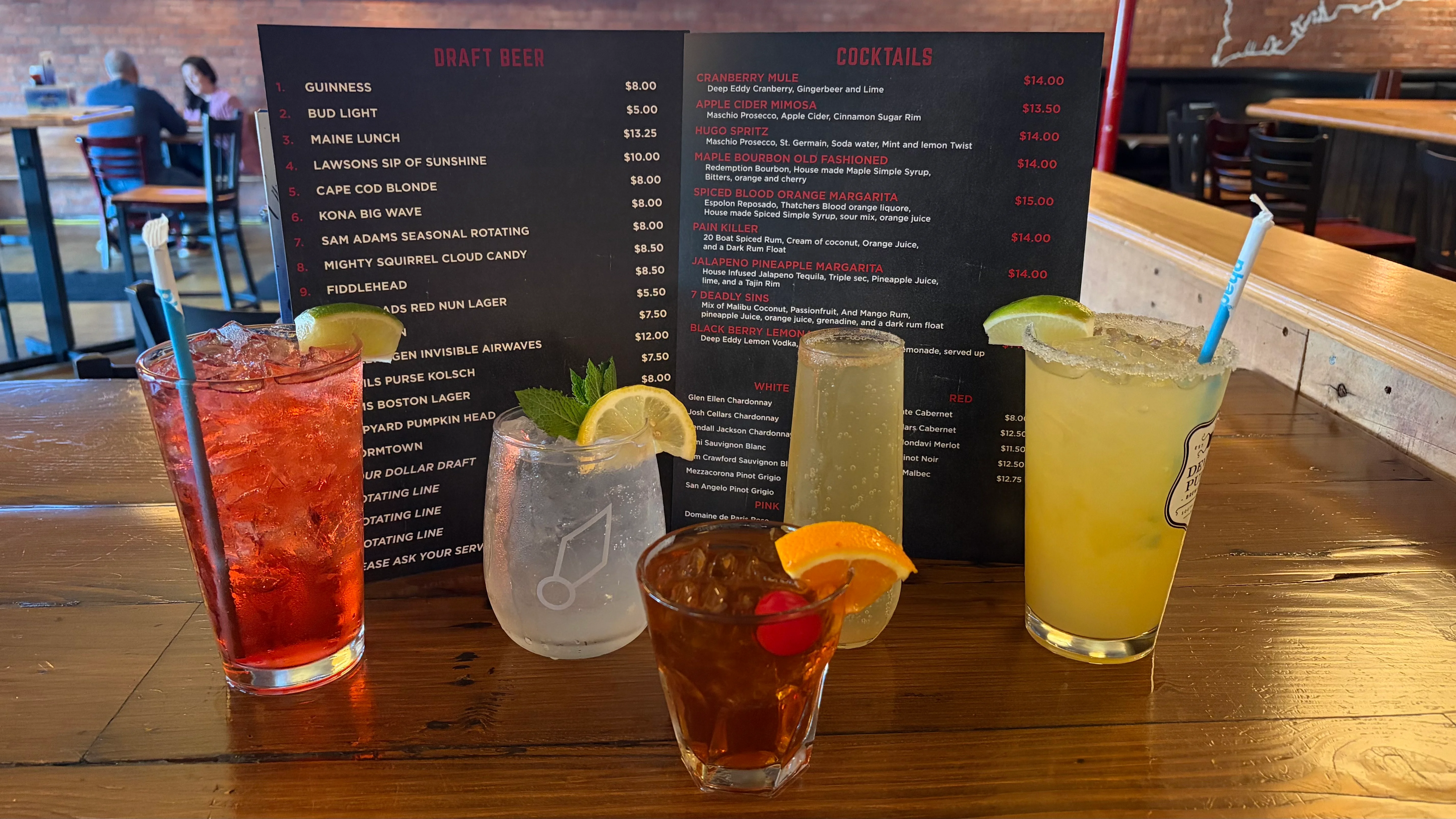 Colorful cocktails and draft beer menu at a lively bar