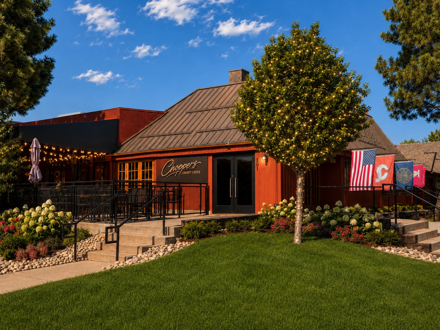 Exterior view of a restaurant with team flags and a welcoming entrance