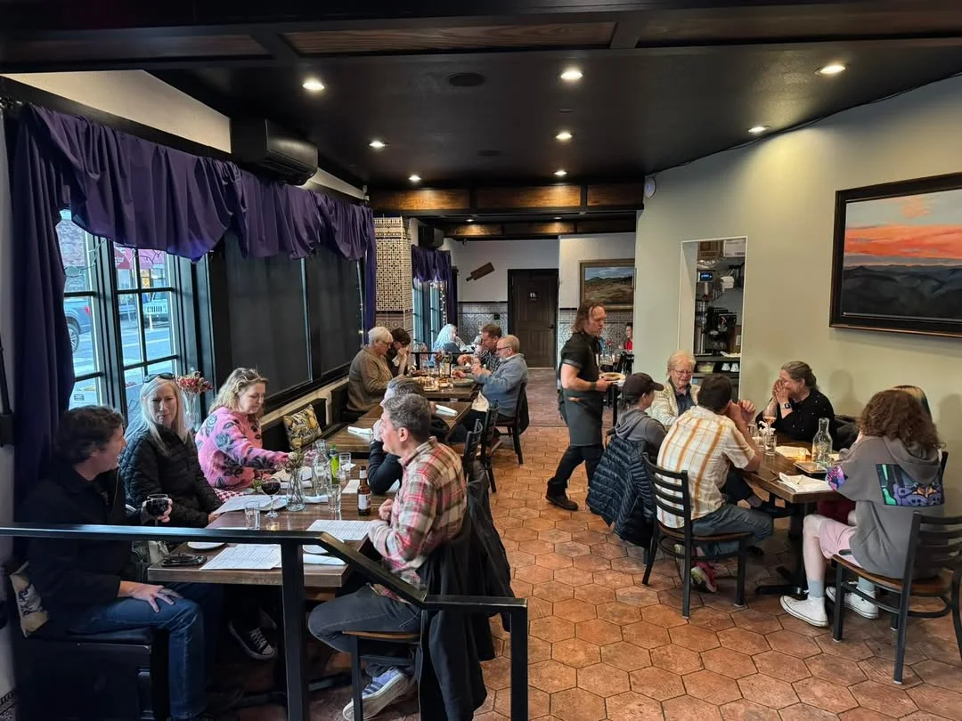 Cozy restaurant interior with diners enjoying meals and drinks
