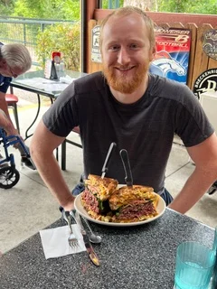 Giant Reuben sandwich served in a casual dining setting