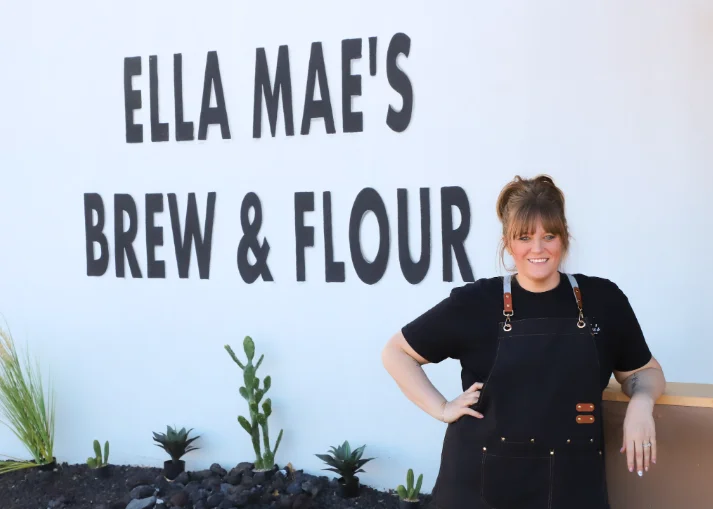 Owner posing outside Ella Mae's Brew & Flour restaurant