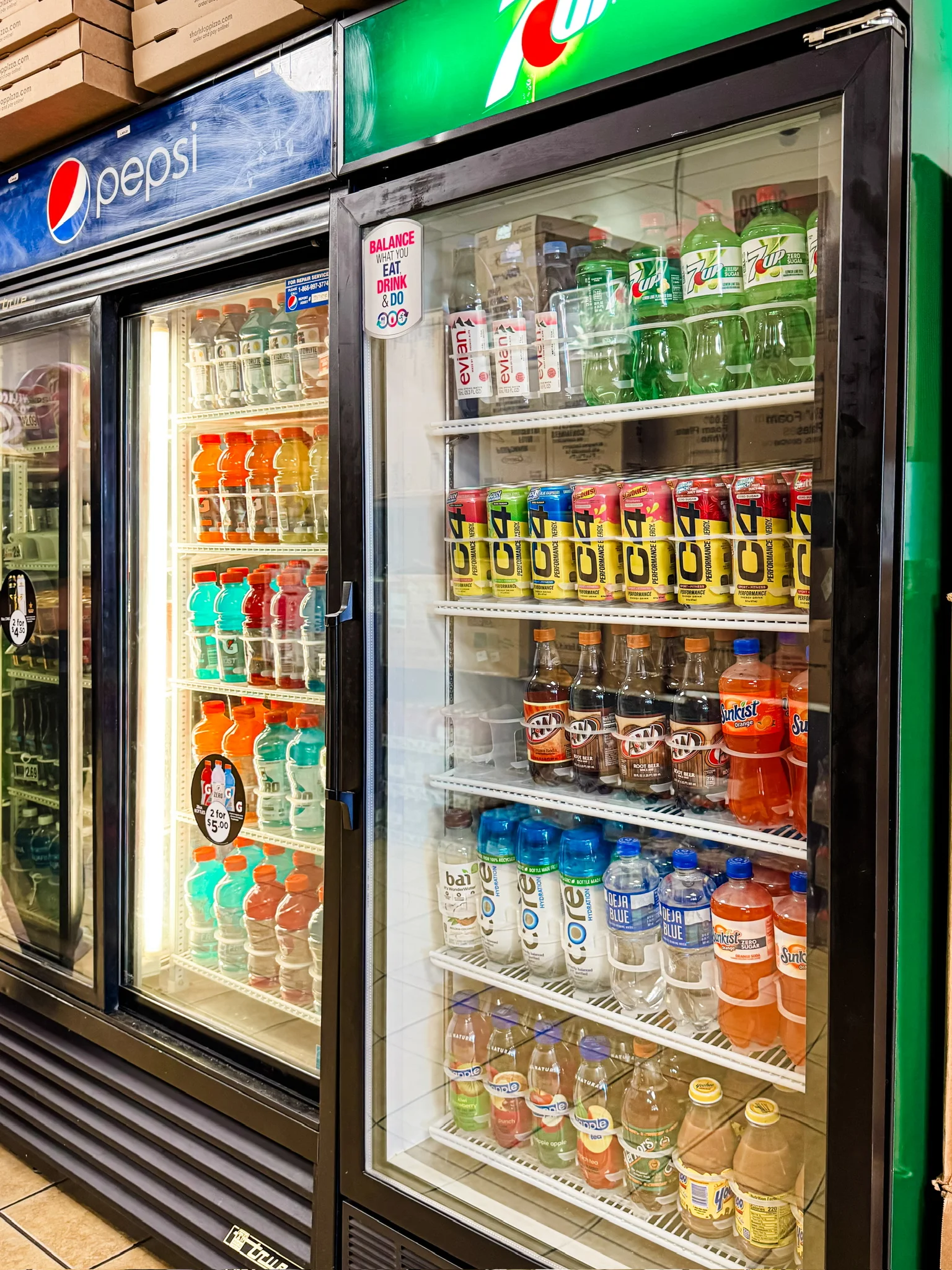 Beverage cooler stocked with various drinks and sodas