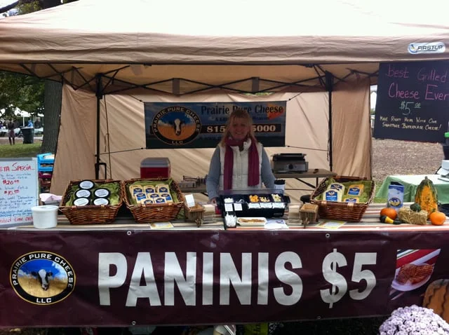 Cheese vendor at a market selling grilled paninis