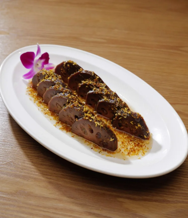 Sliced Chinese lotus root dish garnished with herbs