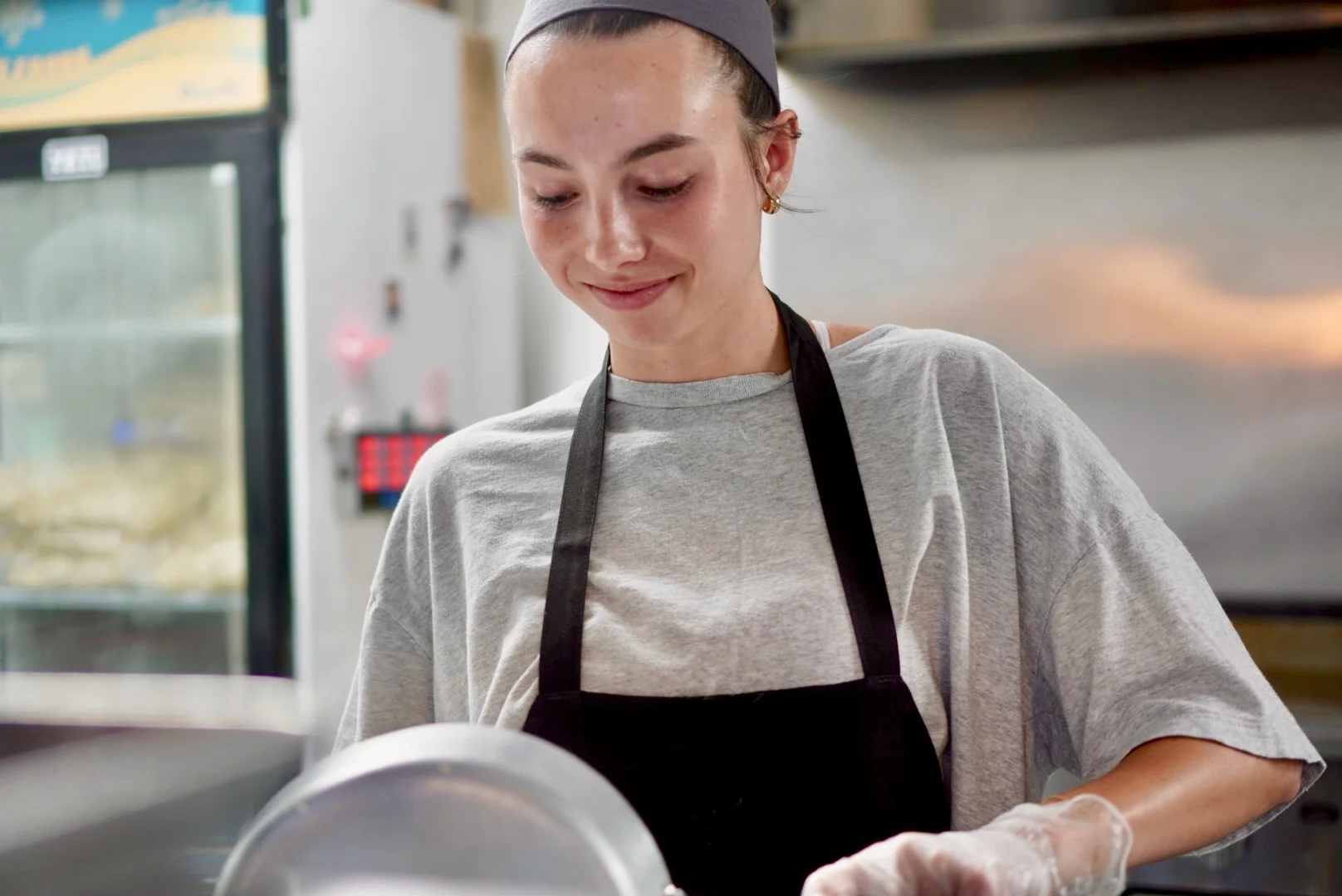 Borough Employee Holding a Pan and Smiling