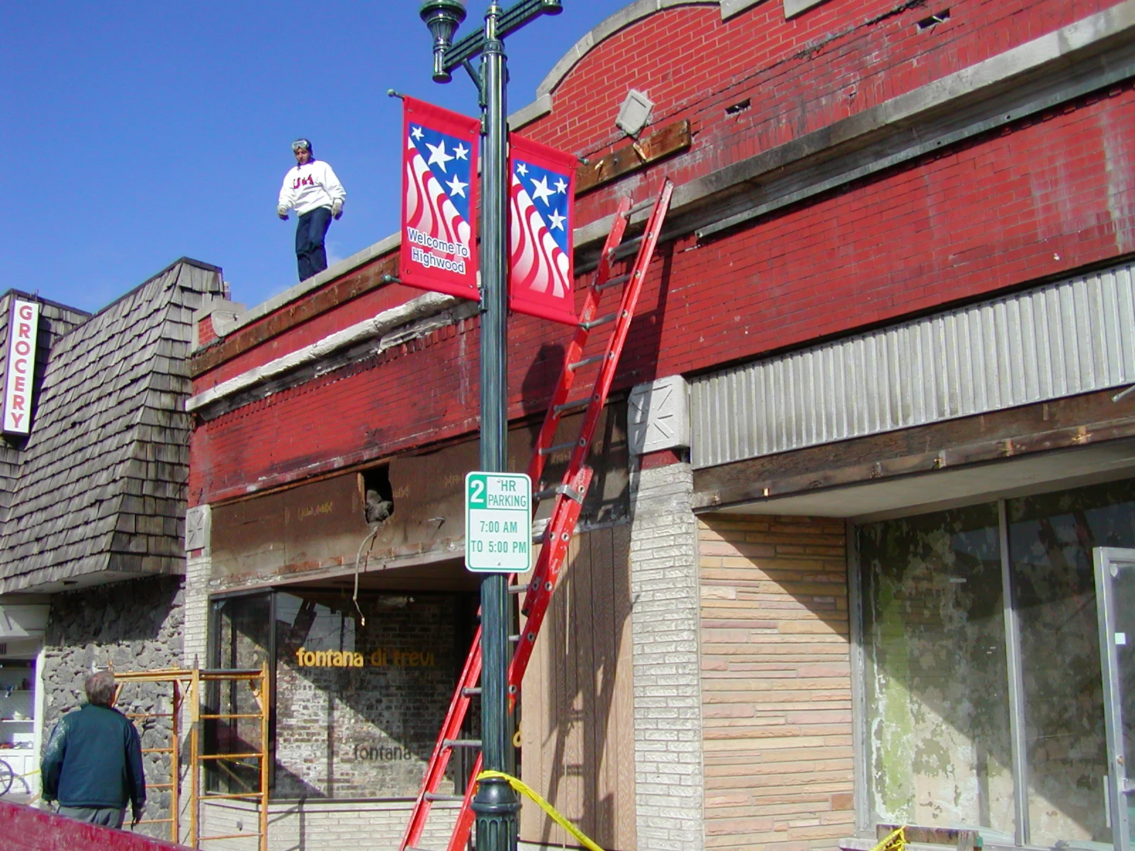 Building renovation with workers and ladders in a vibrant urban setting