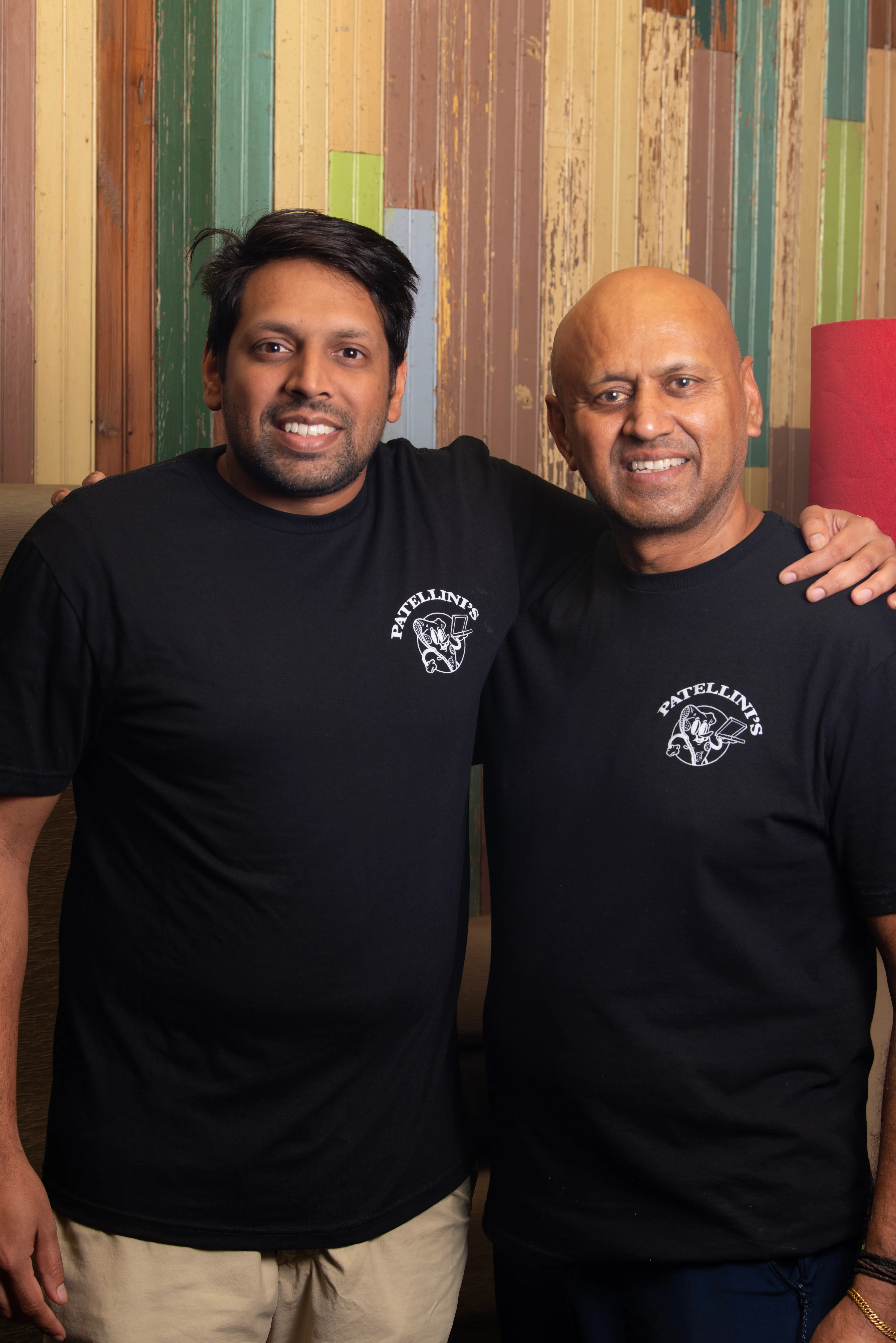 Two restaurant staff members posing together in branded t-shirts