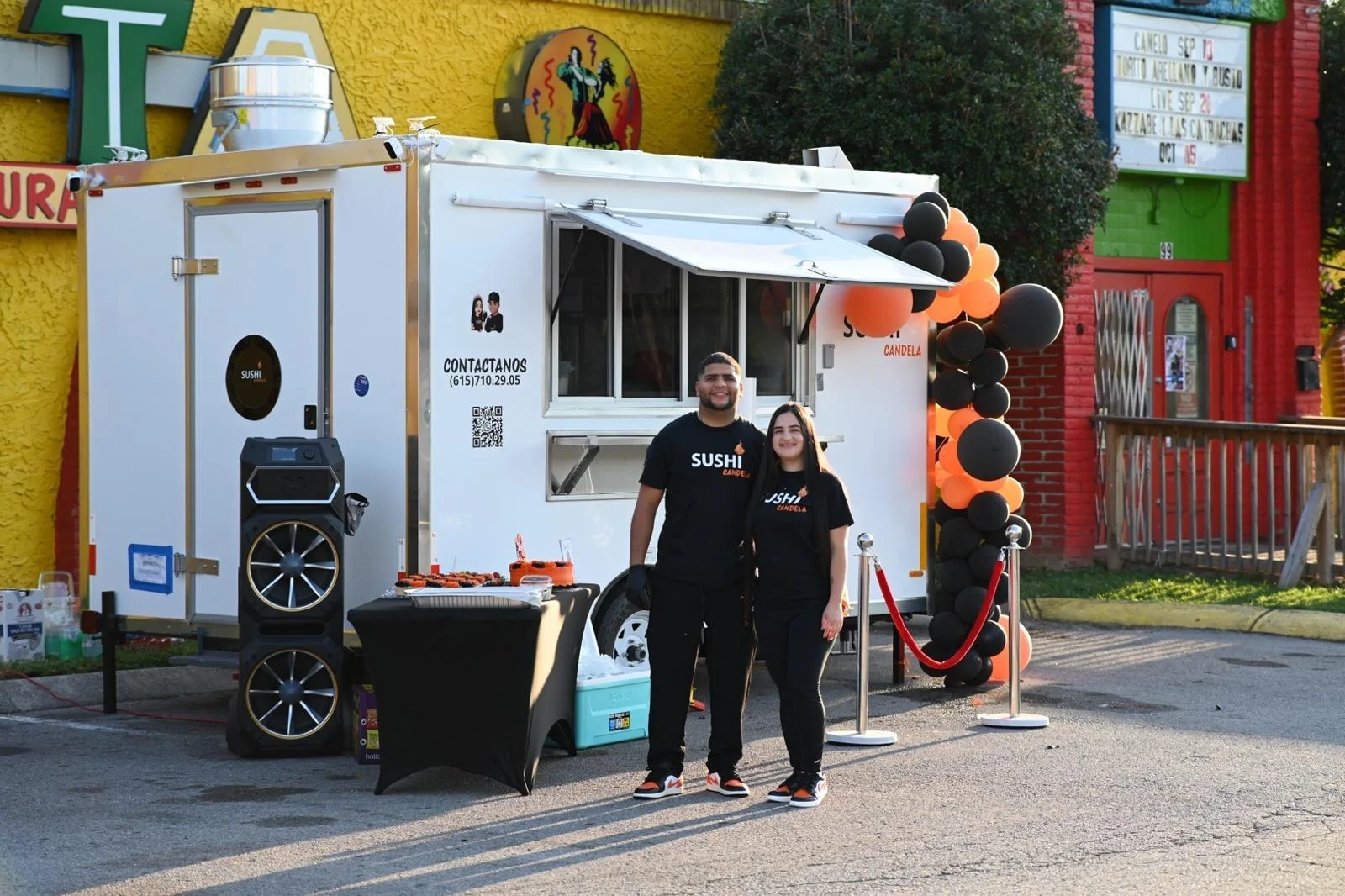 Sushi food truck with vibrant decor and staff
