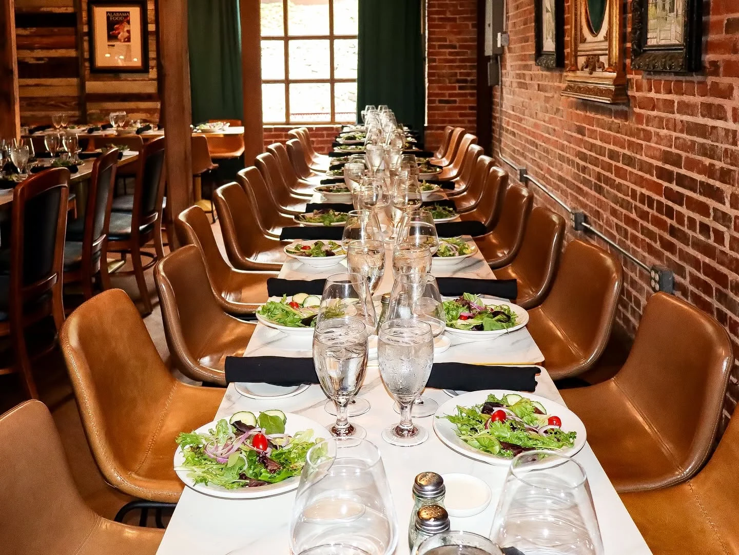 Elegant restaurant dining setup with salads and water glasses