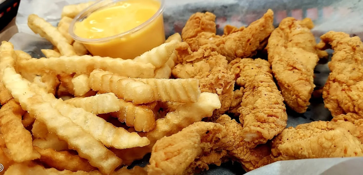 Crispy Southern fried chicken tenders with crinkle-cut fries