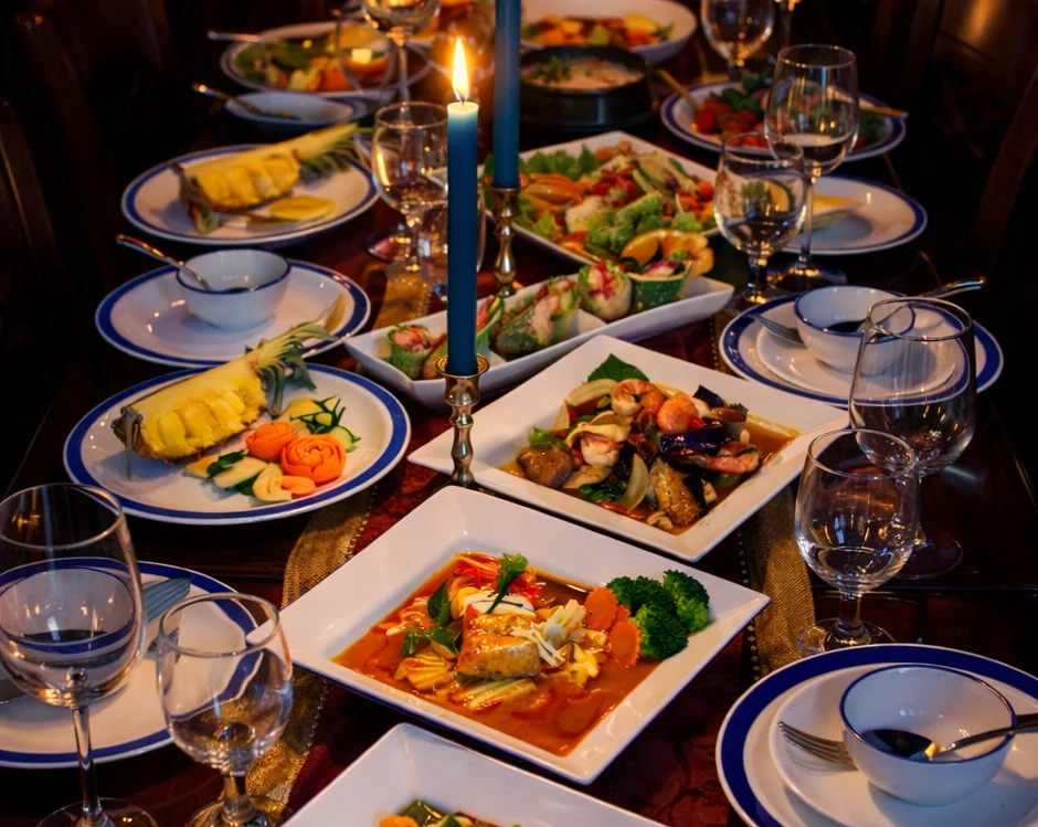 Elegant Thai dinner spread with colorful dishes and candles