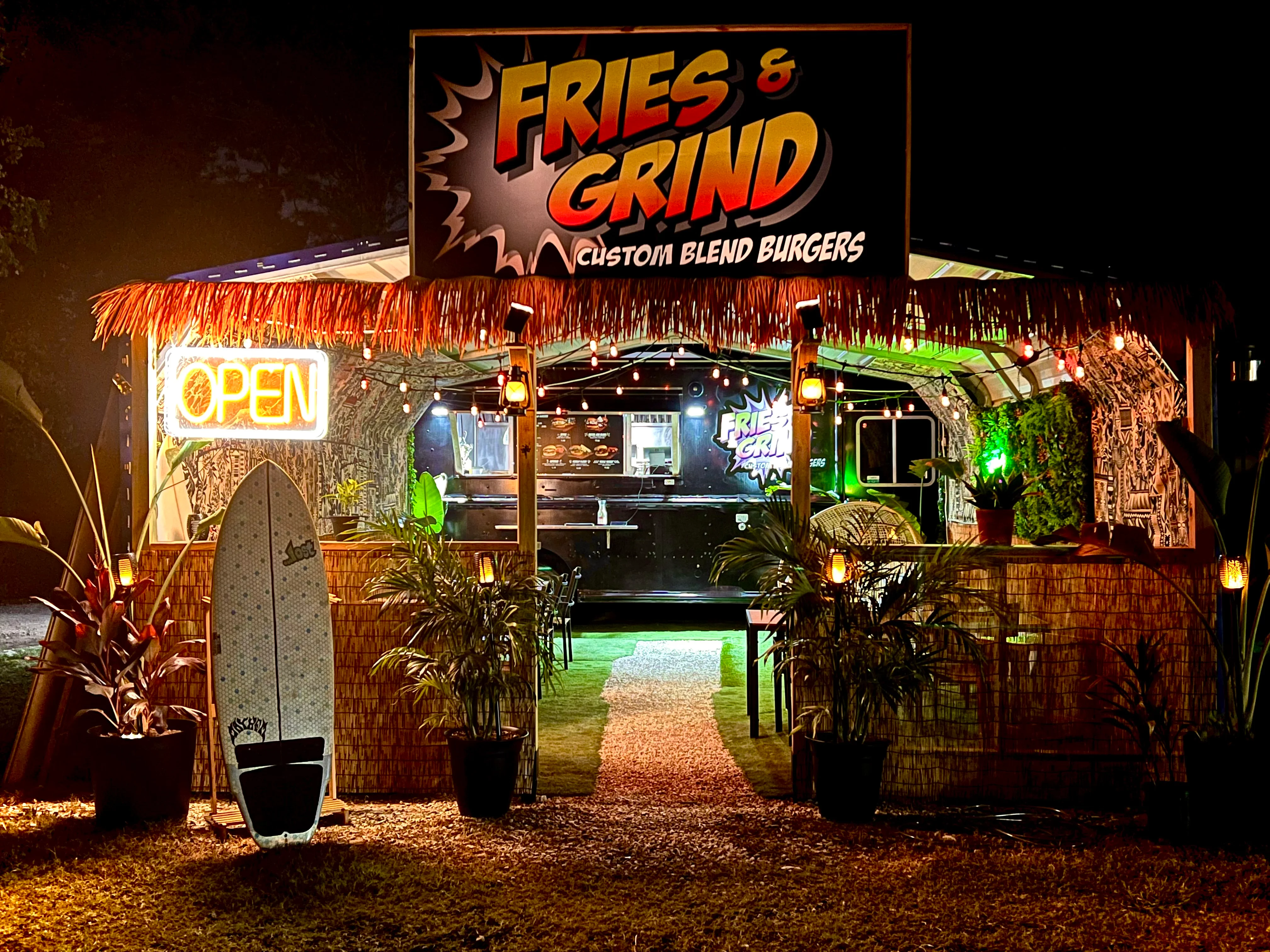 Vibrant food truck serving custom blend burgers at night