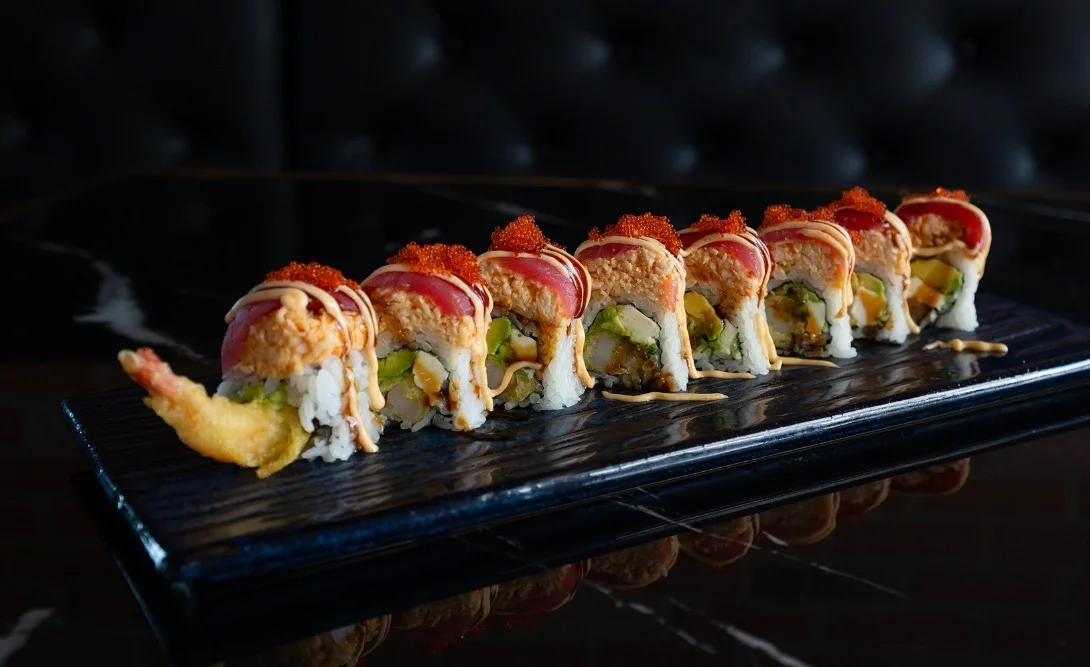 Japanese sushi rolls beautifully presented on a black plate