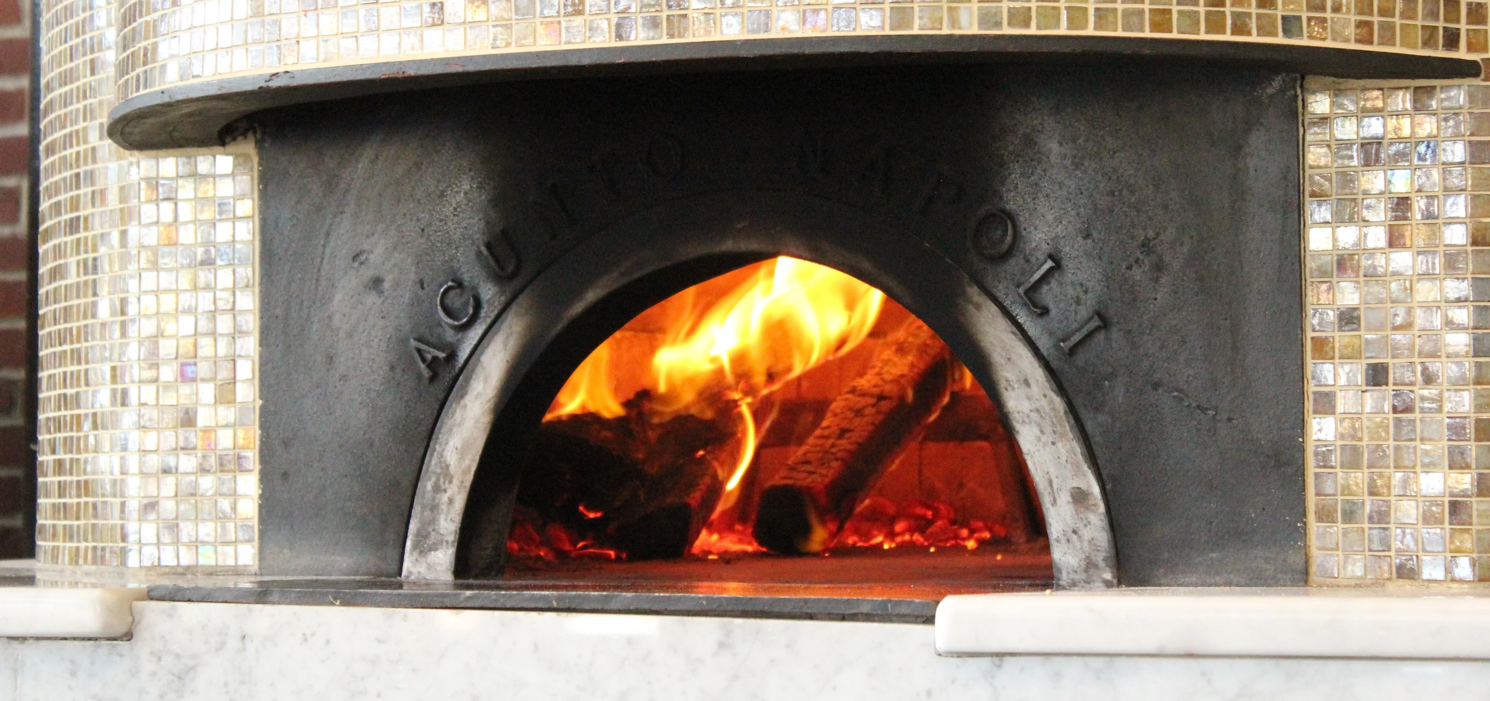 Wood-fired oven with flames for authentic Neapolitan pizza
