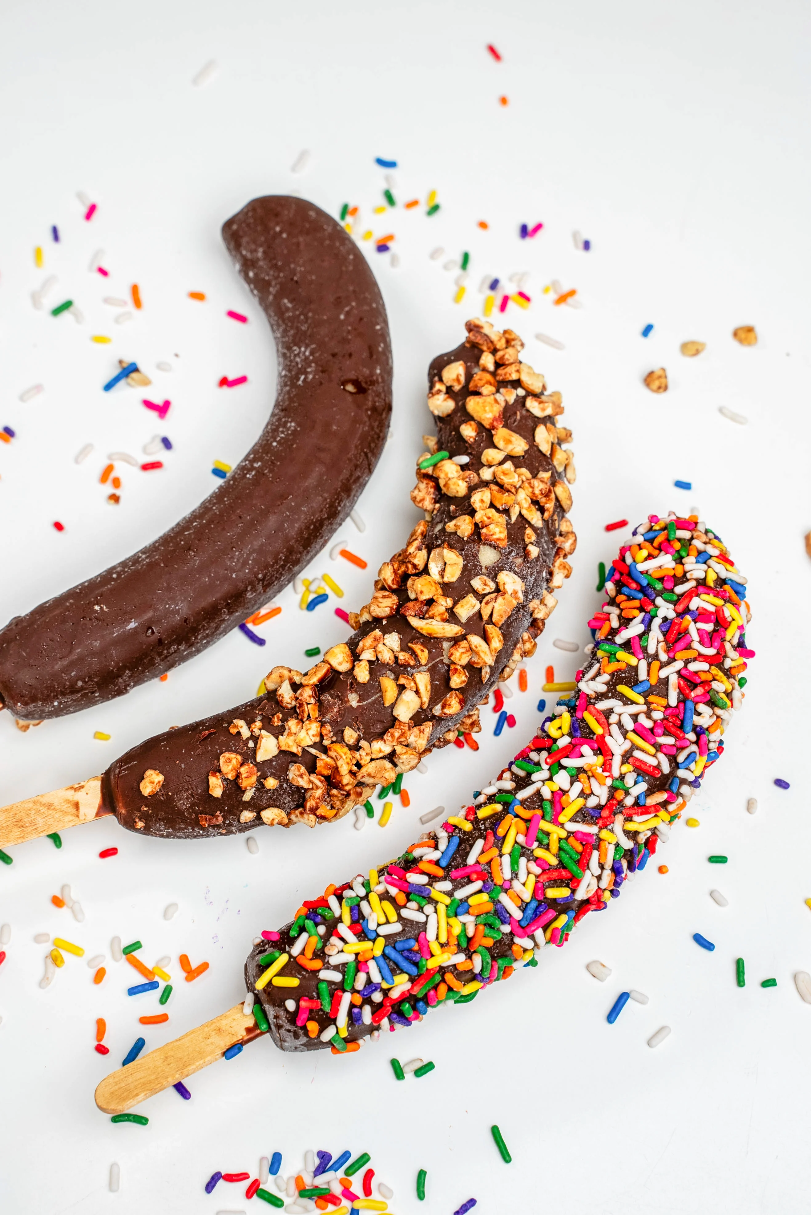 Chocolate-covered frozen bananas with colorful sprinkles