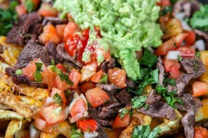 Loaded nachos with beef, guacamole, and fresh salsa