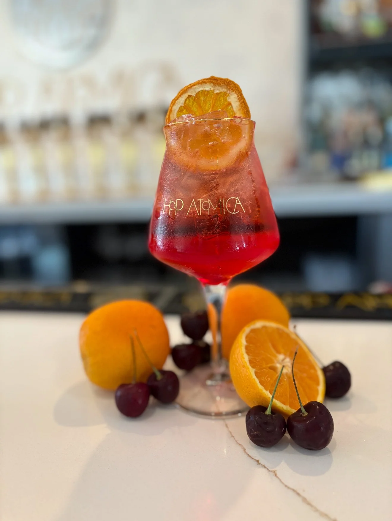 Colorful cocktail garnished with orange and cherries
