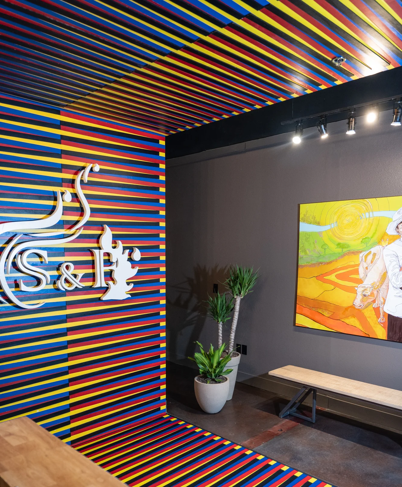 Vibrant restaurant interior with colorful striped walls and artwork
