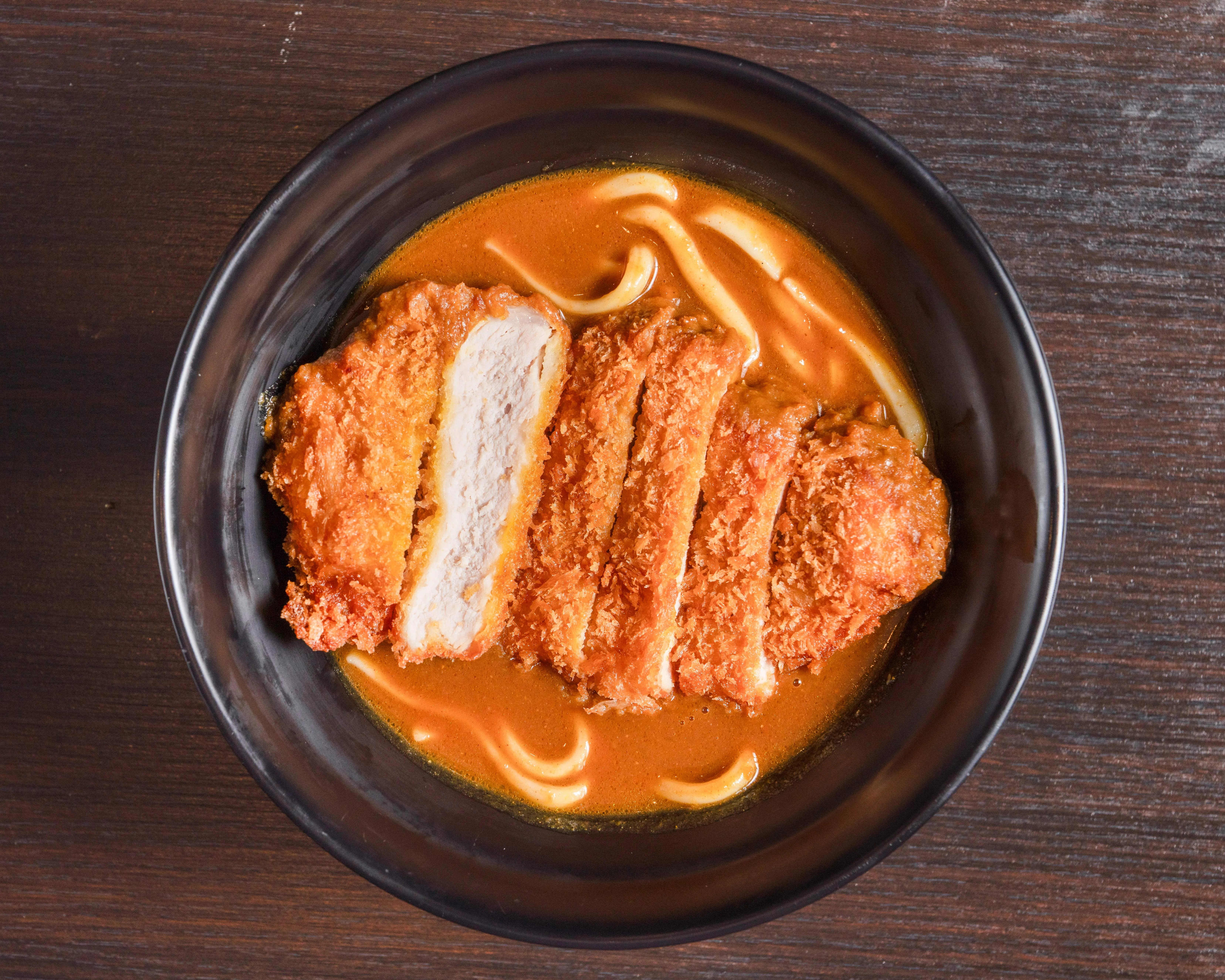 Japanese katsu curry with crispy chicken cutlet and udon noodles