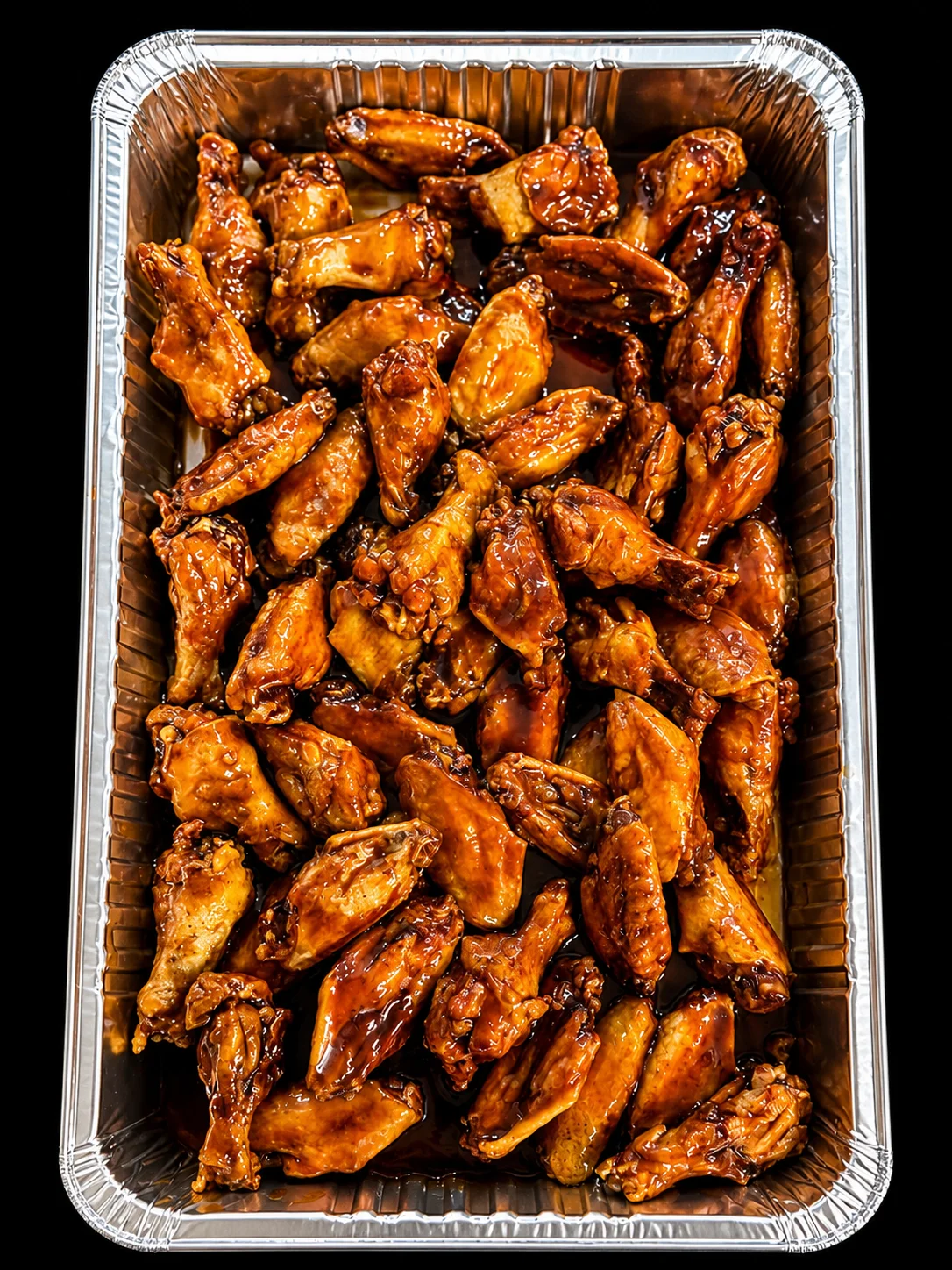 Crispy buffalo chicken wings in a serving tray