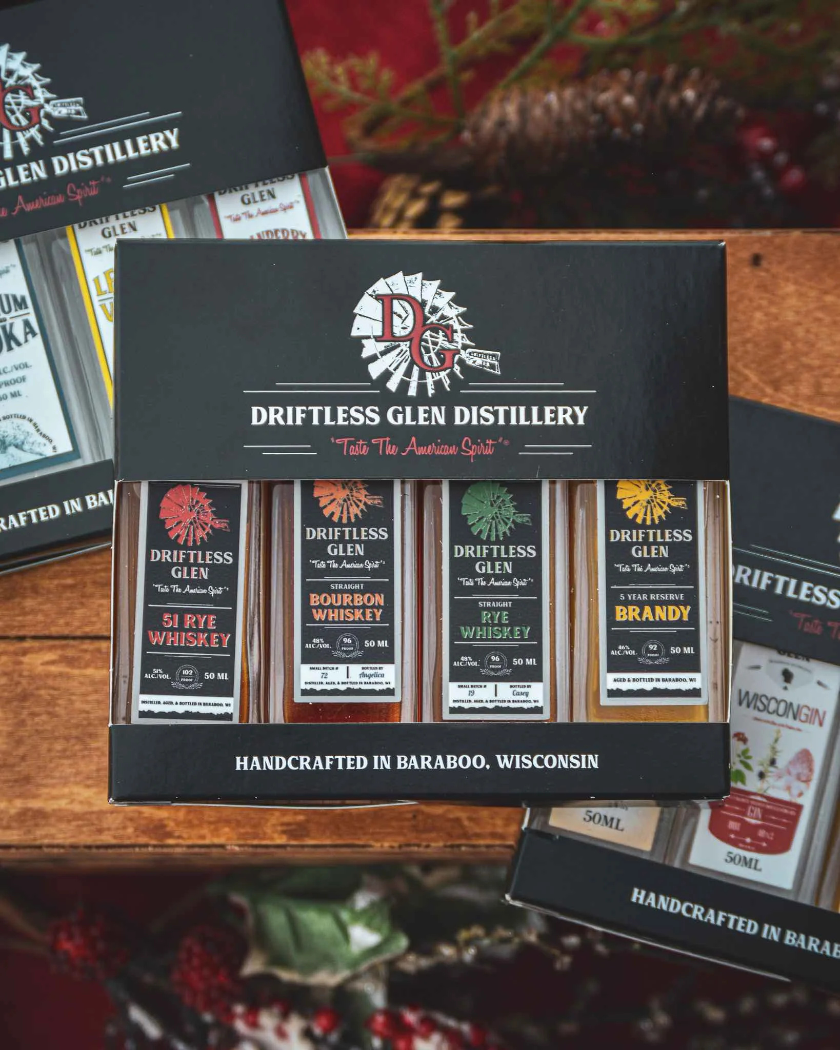 An image of the 4-pack of 50 ml bottles surrounded by holiday decor