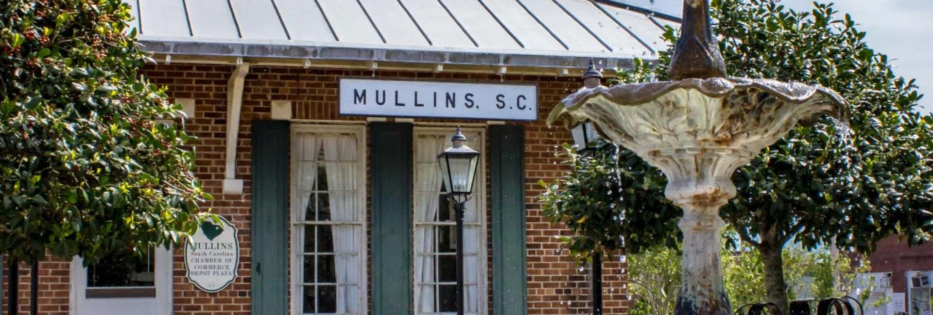 Historic building in Mullins, South Carolina with a decorative fountain