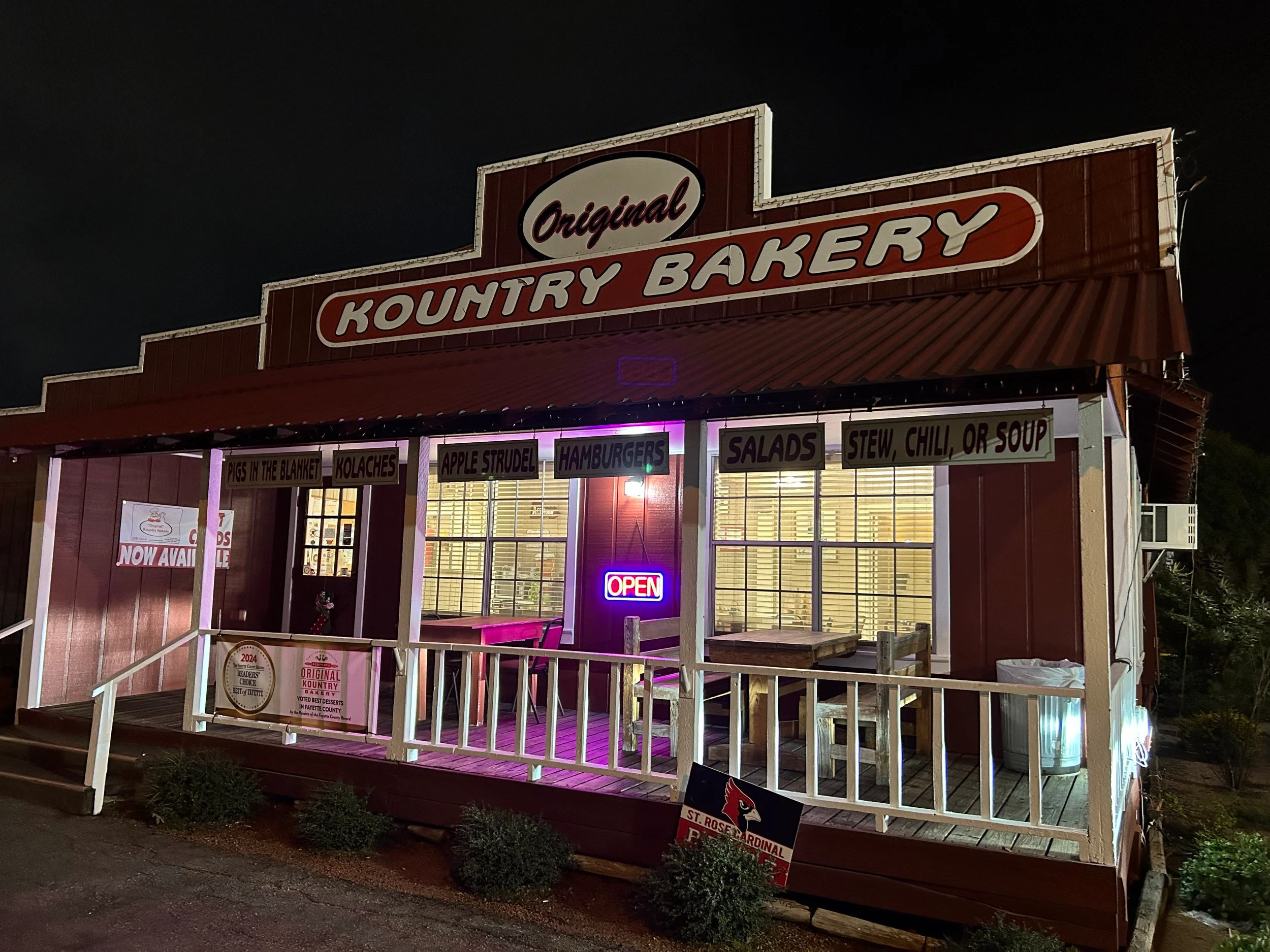 Charming bakery exterior with open sign and menu highlights