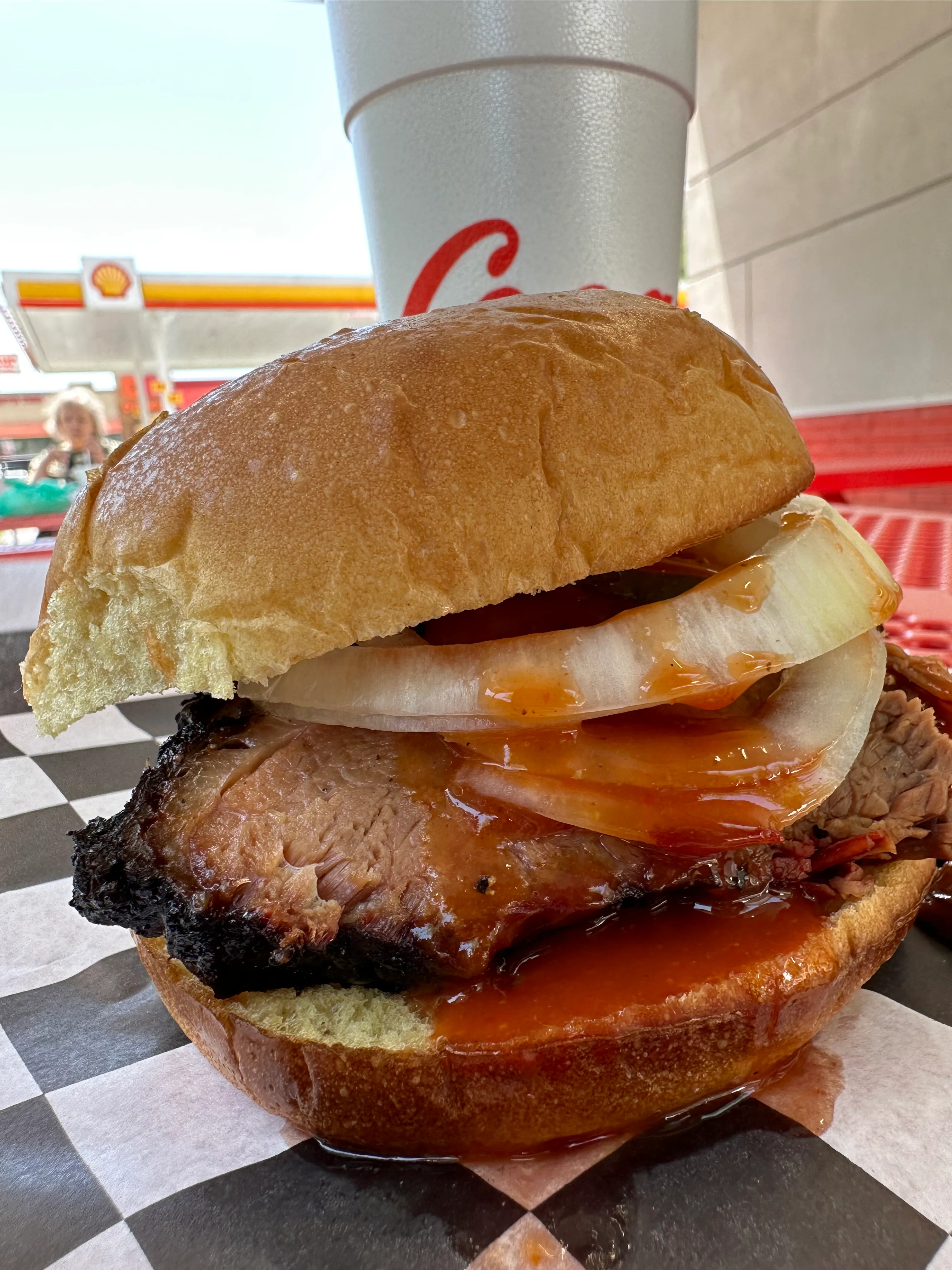 Delicious burger with toppings served on a wooden table