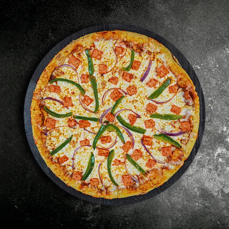 Delicious Indian-style paneer pizza with vibrant toppings