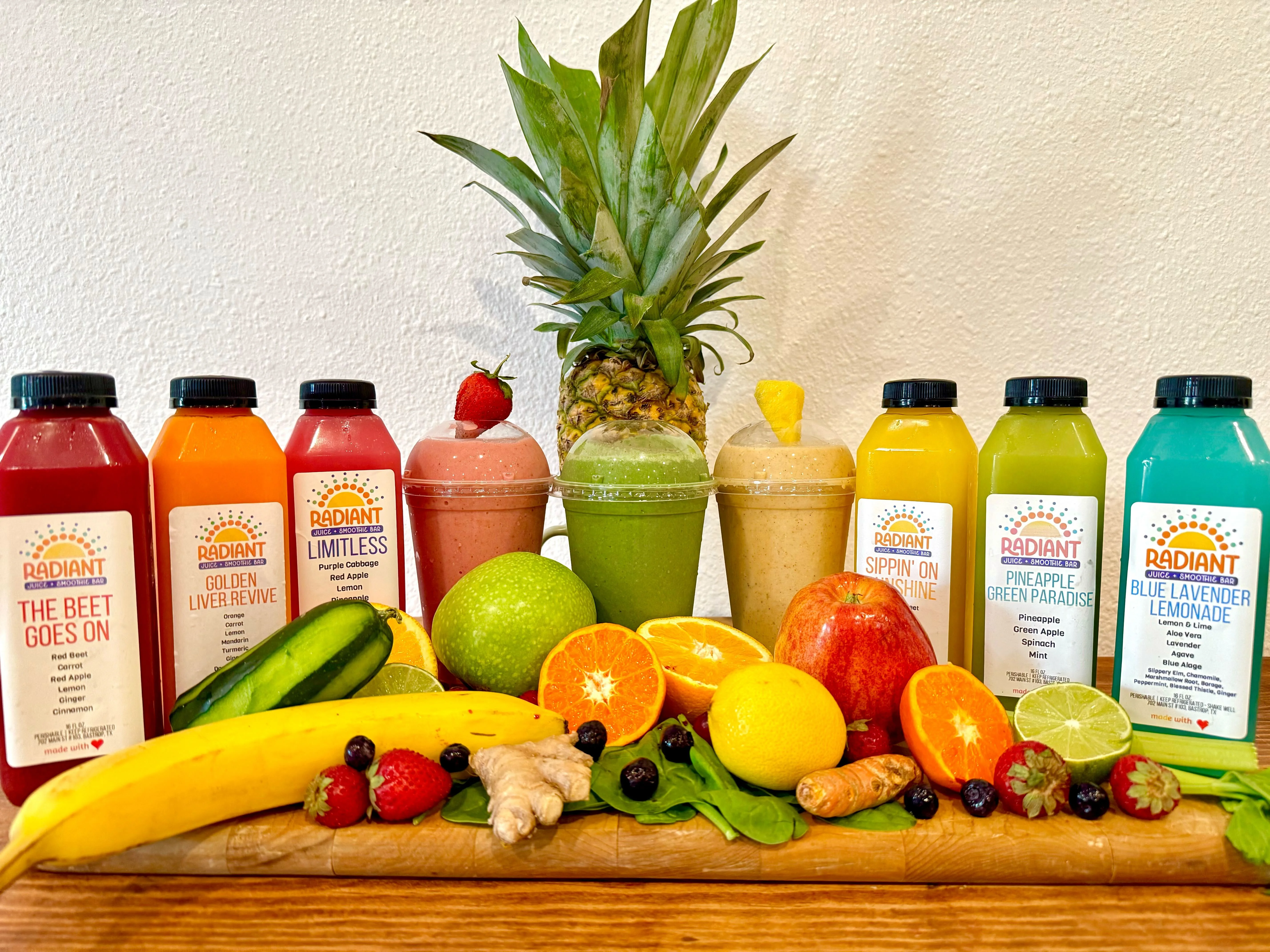 Colorful array of fresh juices and smoothies on a wooden table