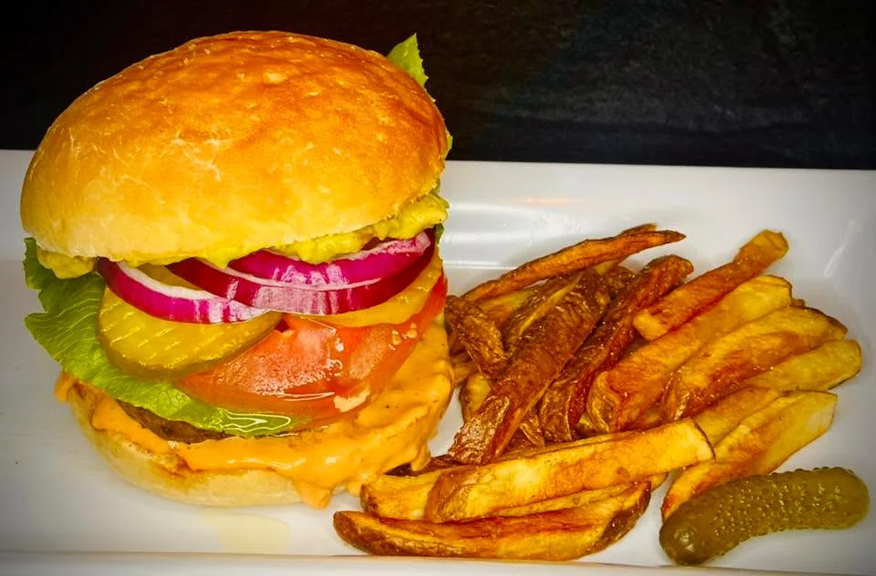 Delicious gourmet burger with fresh toppings on a wooden table