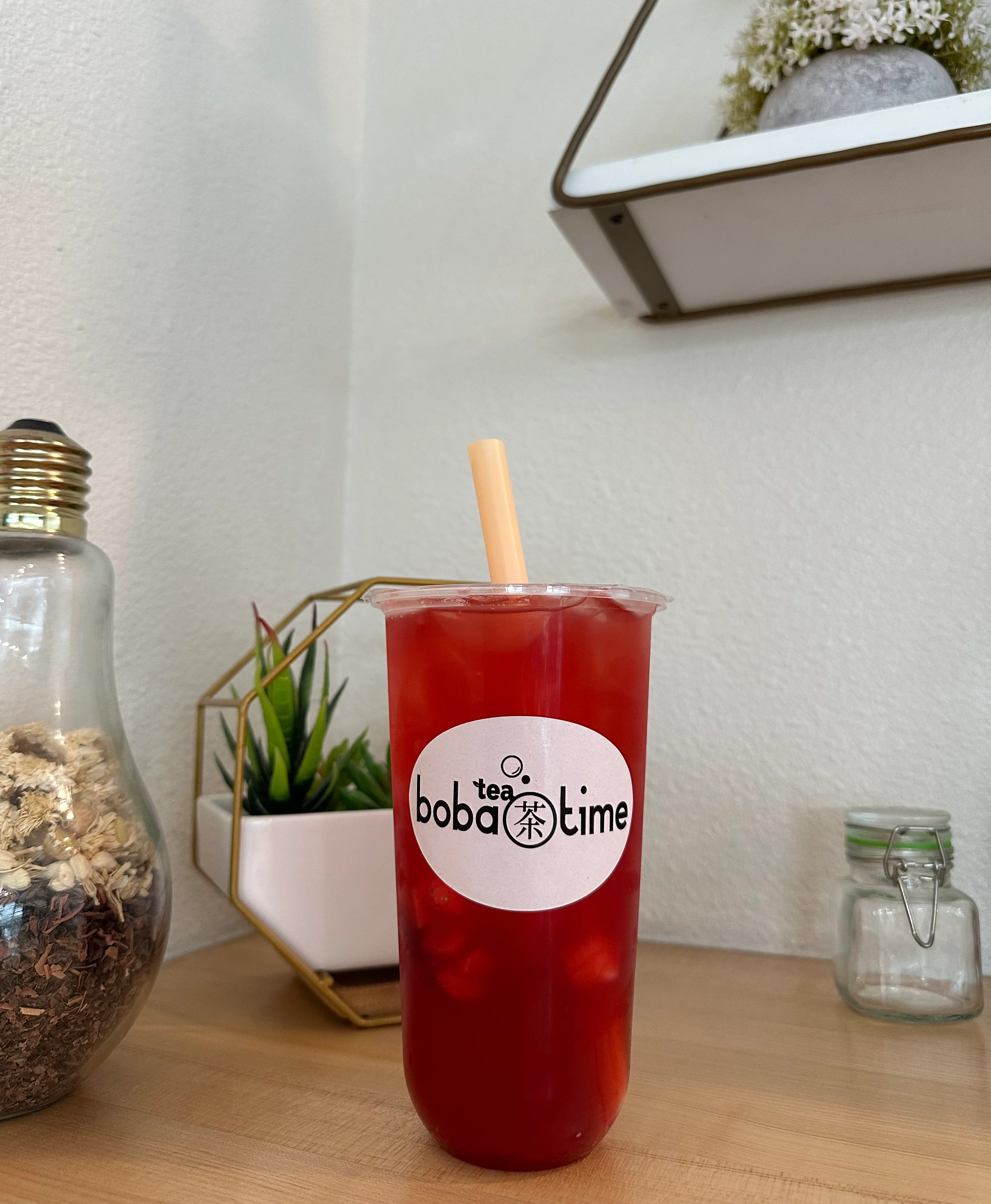 Refreshing fruit tea with boba pearls in a clear cup