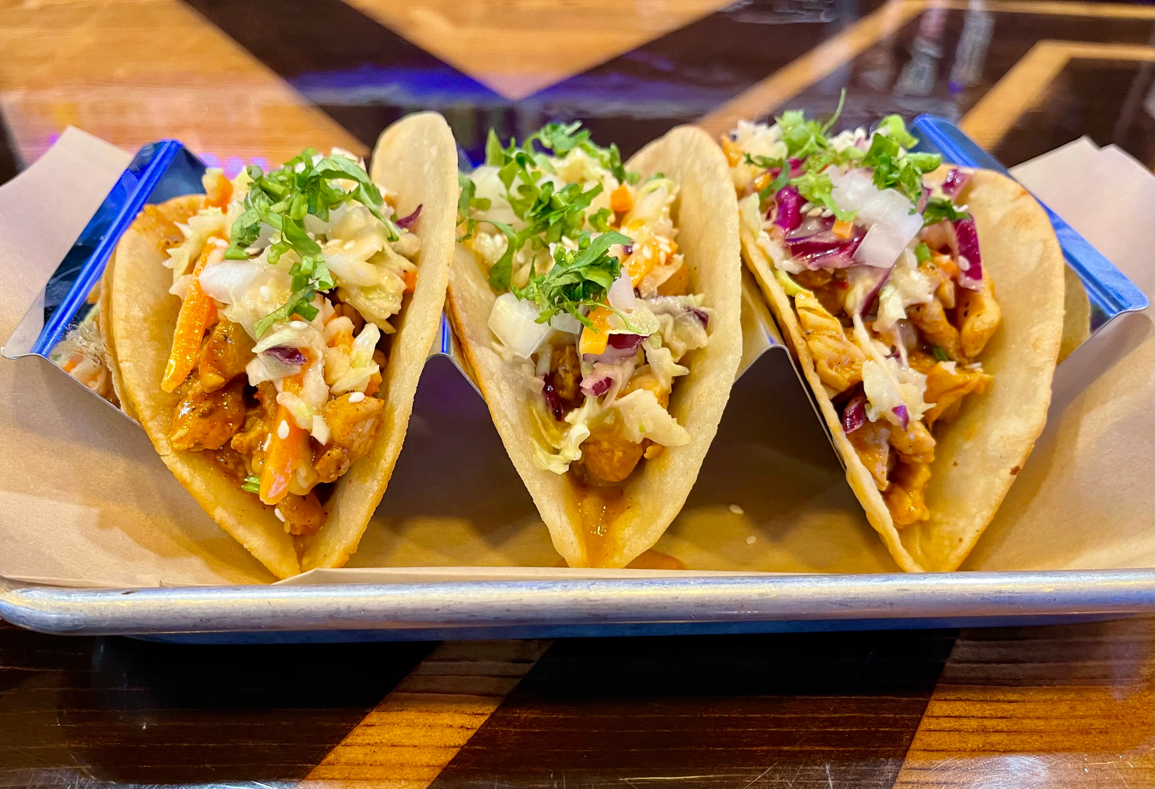 Three delicious tacos served on a tray